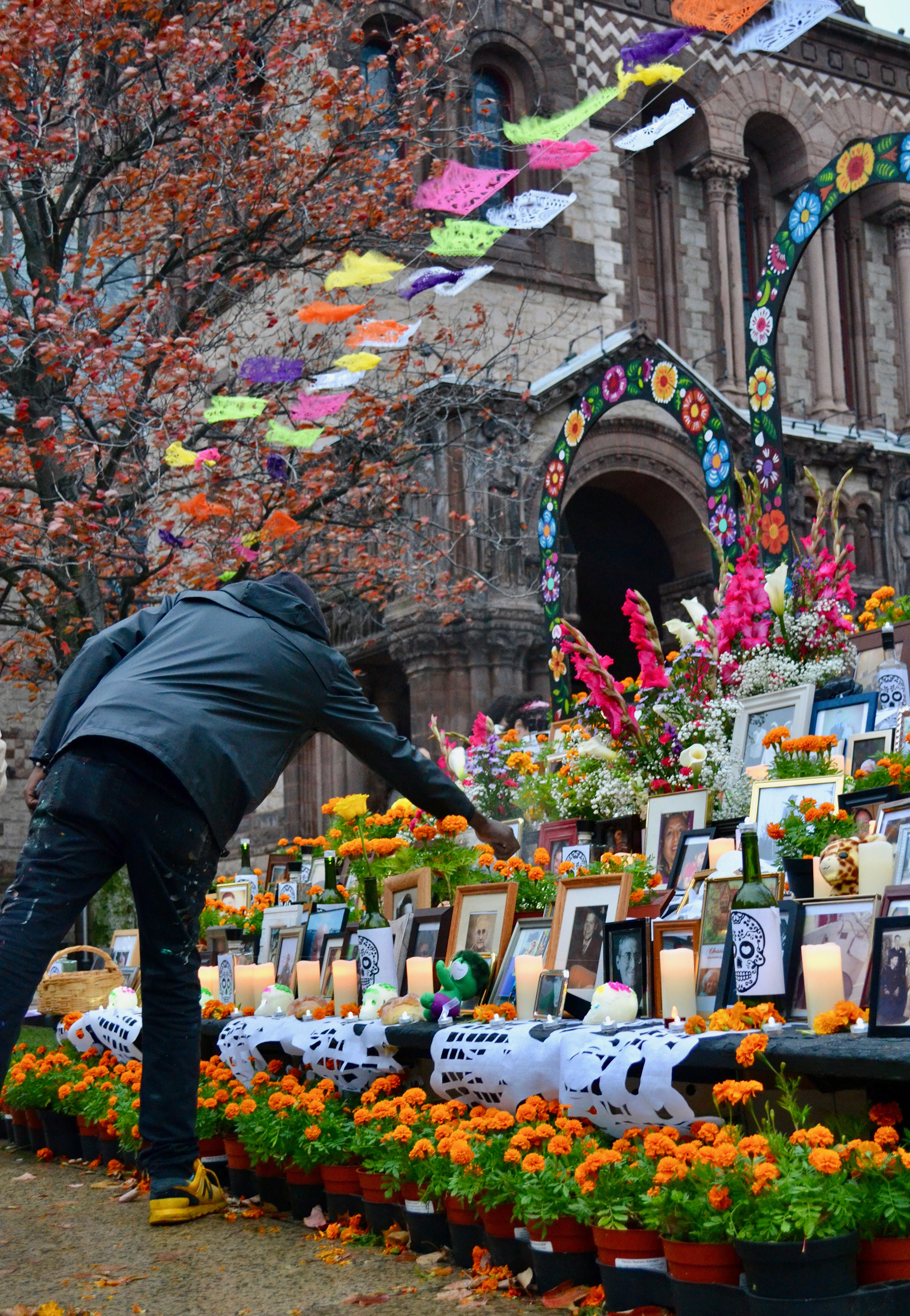 Boston Parks and Recreation Department employee, Jerome Jones, tends to the copal incense that is traditionally used on Dia de los Muertos ofrendas.