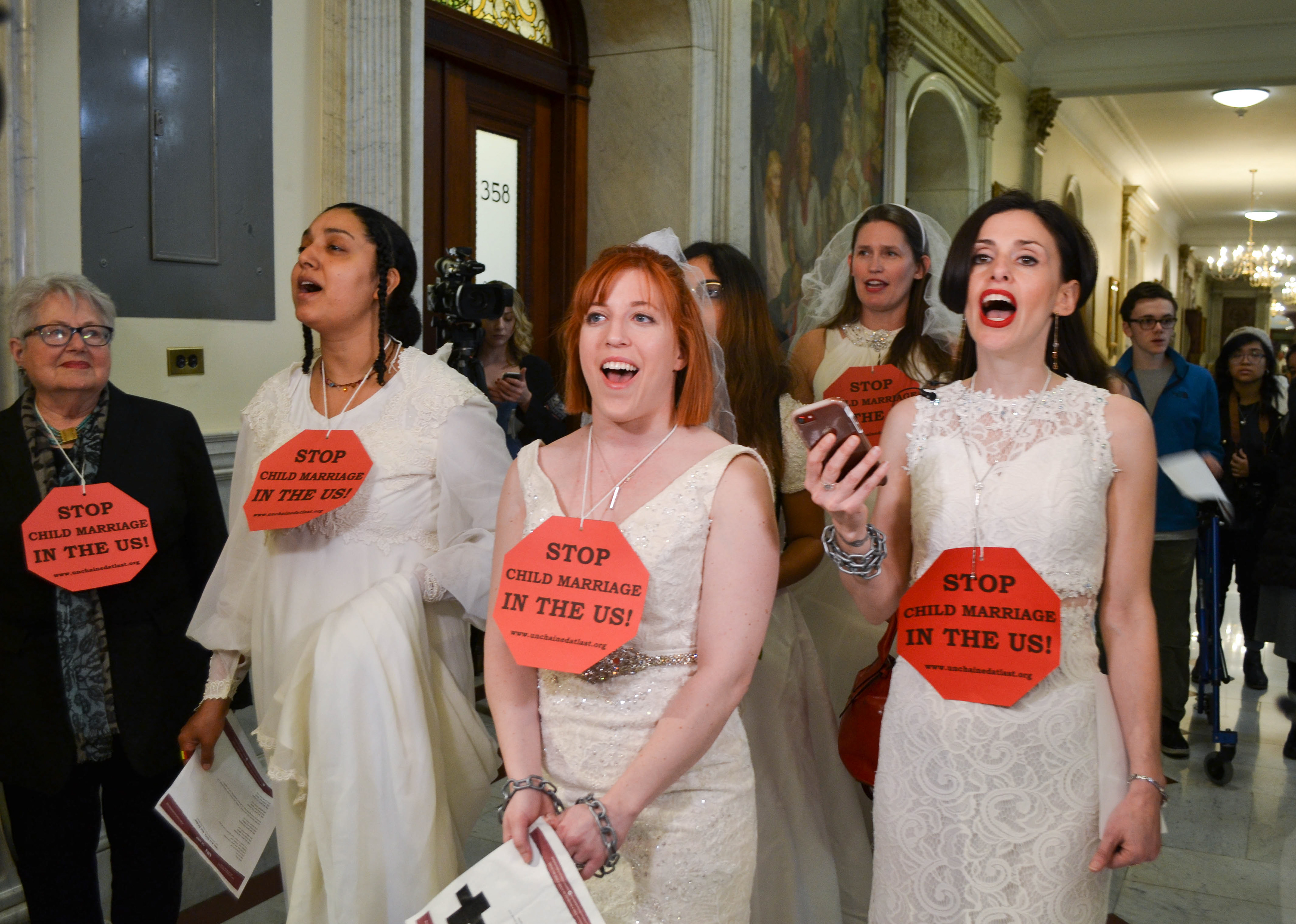 Rep. Kay Khan, Tammy Monteiro, Alex Boyer-Coffey, Amanda Parker and Fraidy Reiss sing in front of Gov. Charlie Baker’s office in protest of the state's child marriage laws in April  2019.