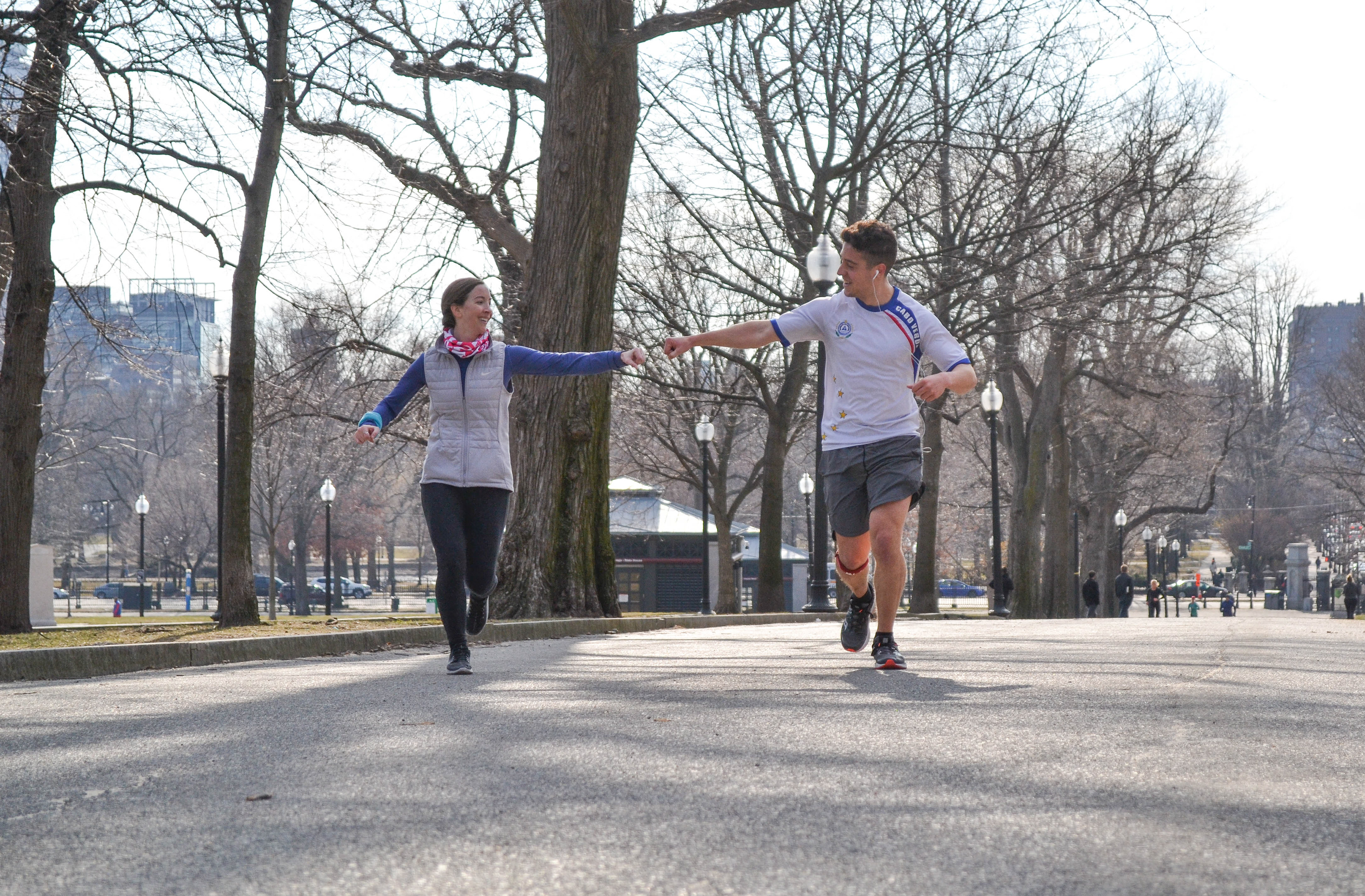 Peter Cunningham (right) and his teammate Jackie Creasey reach out for a fist bump during a March 20 training run in preparation for the 2019 Boston Marathon.