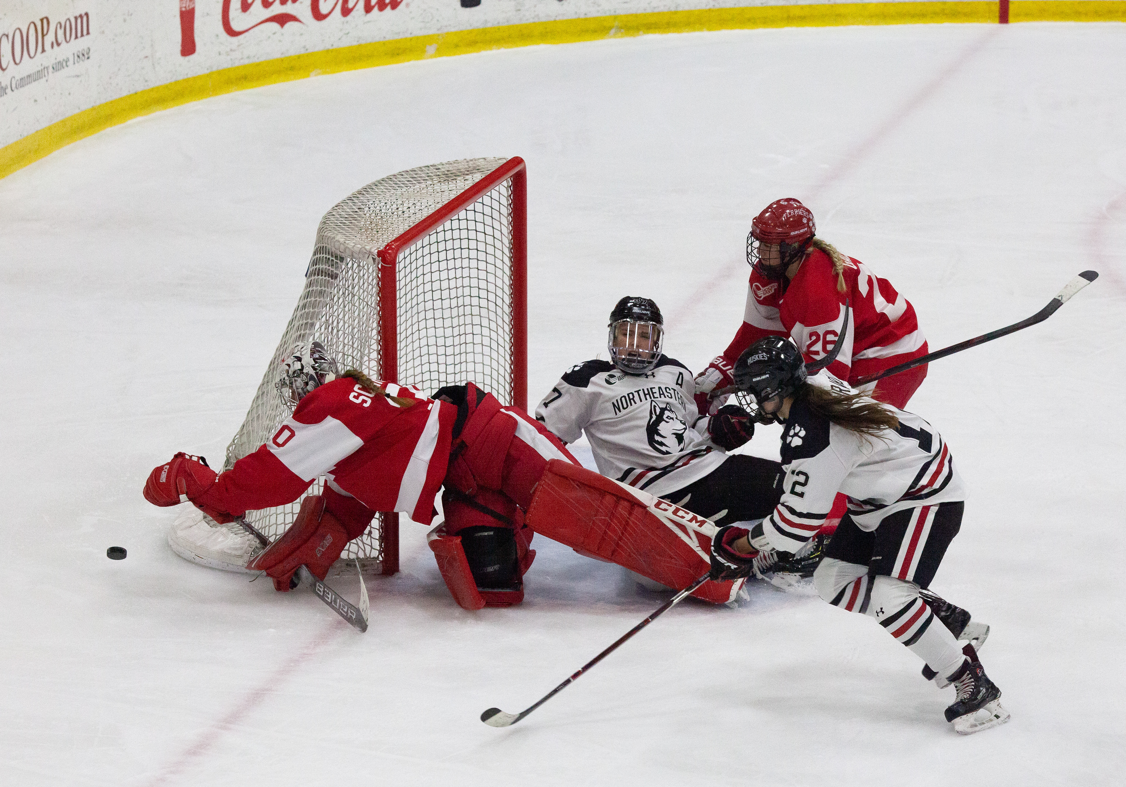 Senior forward Kasidy Anderson and freshmen forward Chloe Aurard crash towards the goal after a scoring opportunity during the 2019 Women's Beanpot at the Bright-Landry Hockey Center.  