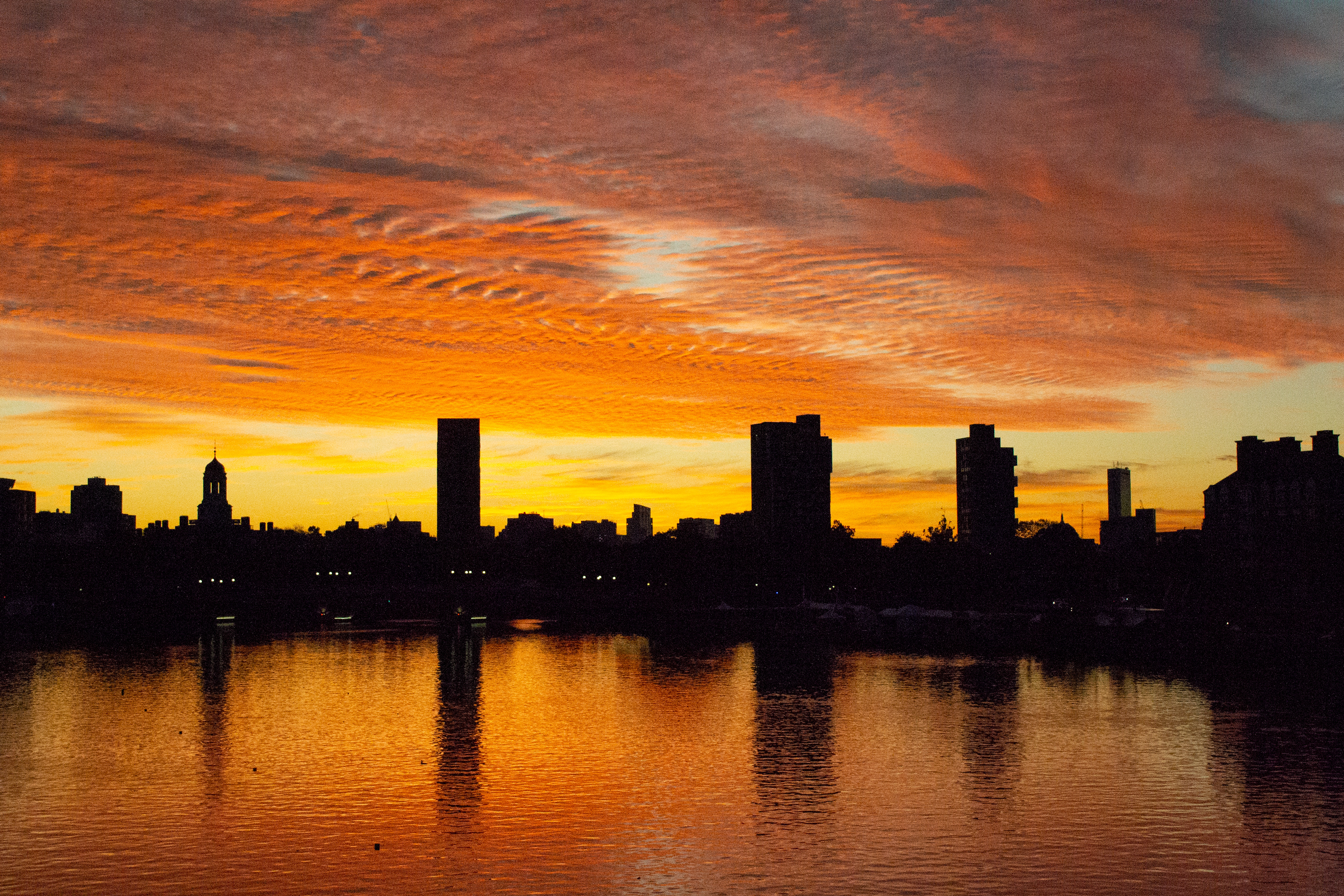 The sun rises over the Charles River on the last morning of the Head of the Charles Regatta in Oct. 2019. 