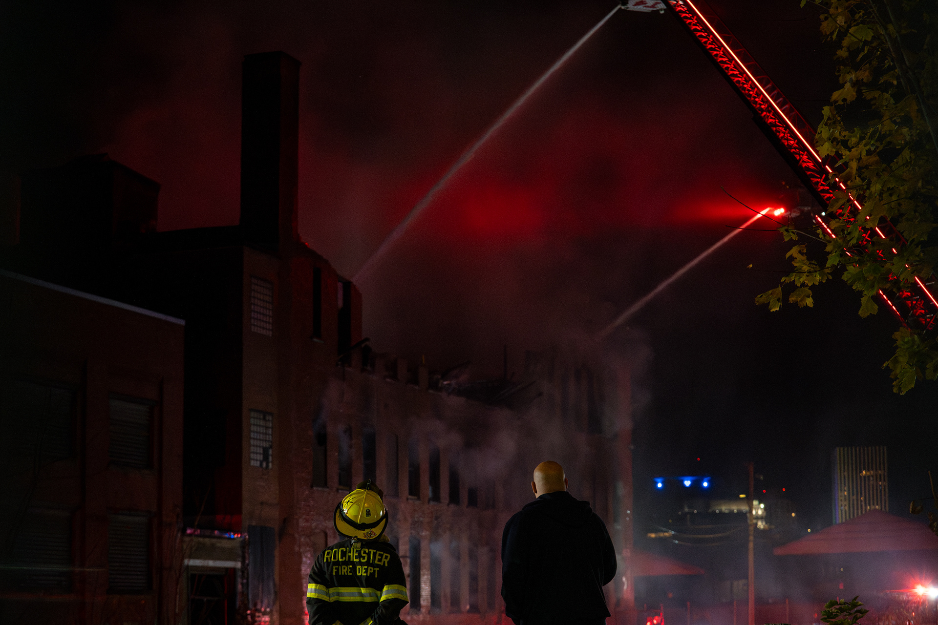 The Rochester Fire Dept. looks on at a four alarm fire that broke out, causing the roof to collapse in a building on Canal St. in Rochester, N.Y. on Nov 18, 2024.