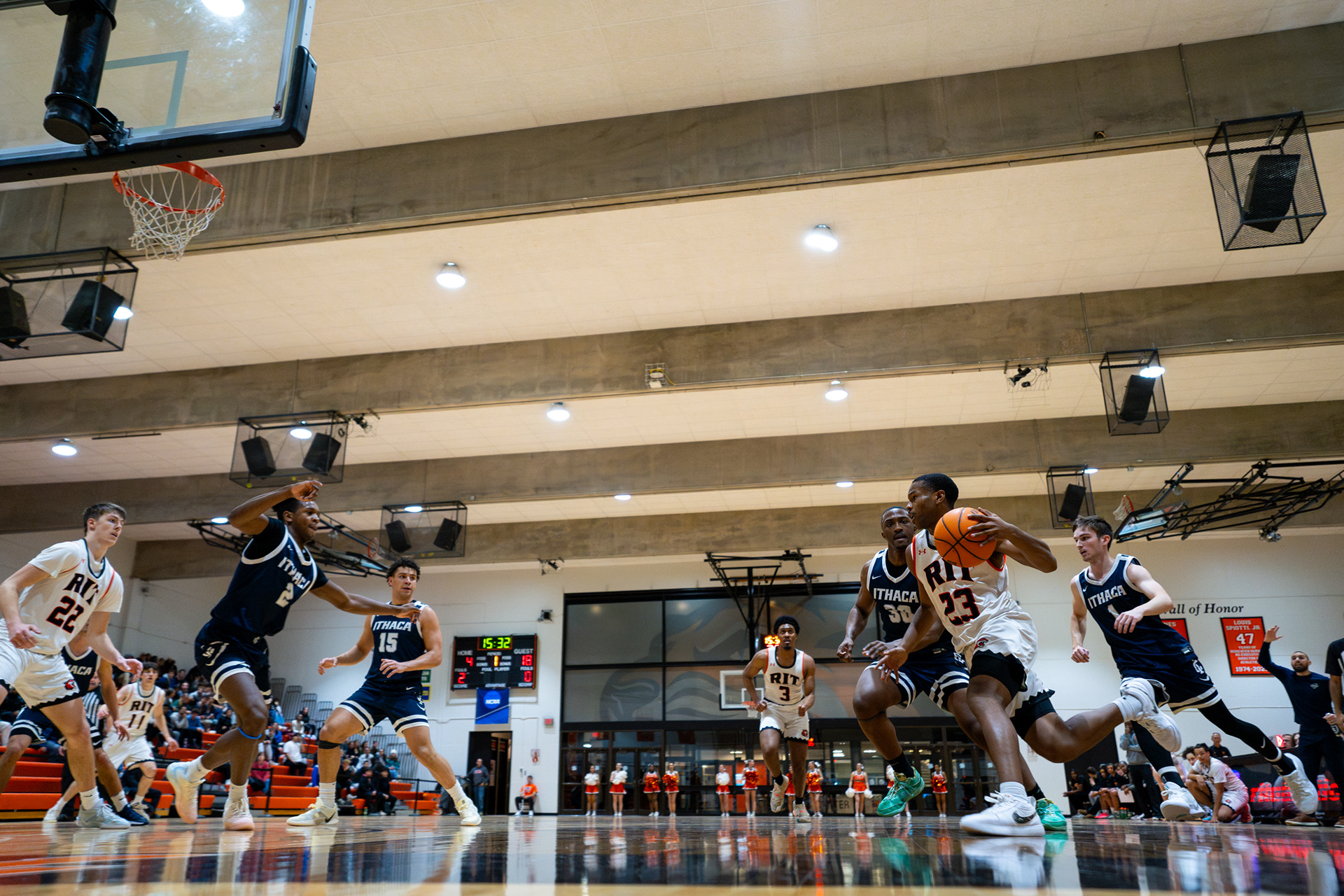 RIT's Mark Osime, #23 dribbles the ball during RIT’s game against Ithaca College in the Clarke Gym at Rochester Institute of Technology on Jan 14, 2025.