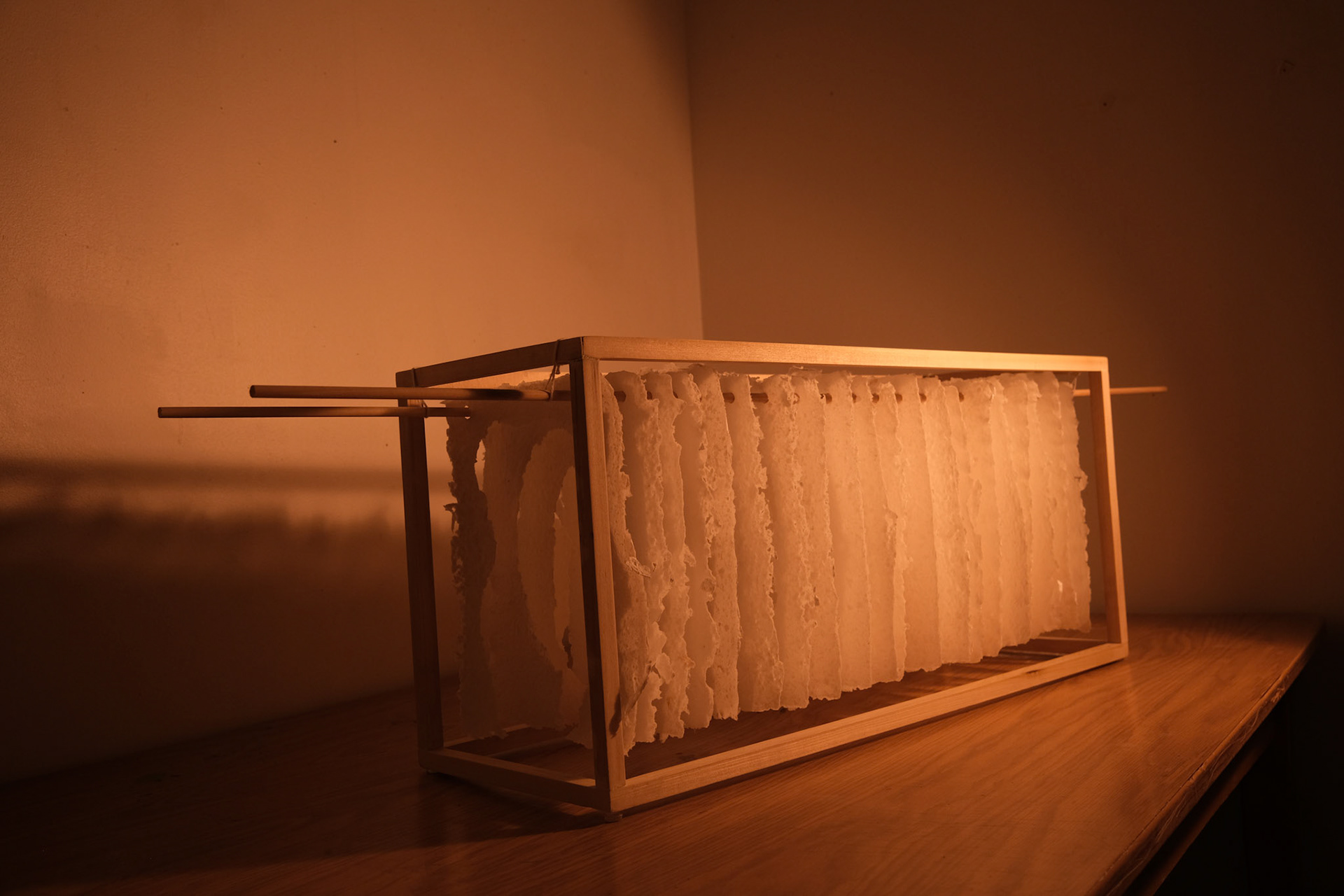 PaperTunnel, Hand-pulled Cotton Paper, Wooden Dowels, Wood, and String. 3' x 1' x 1.5'