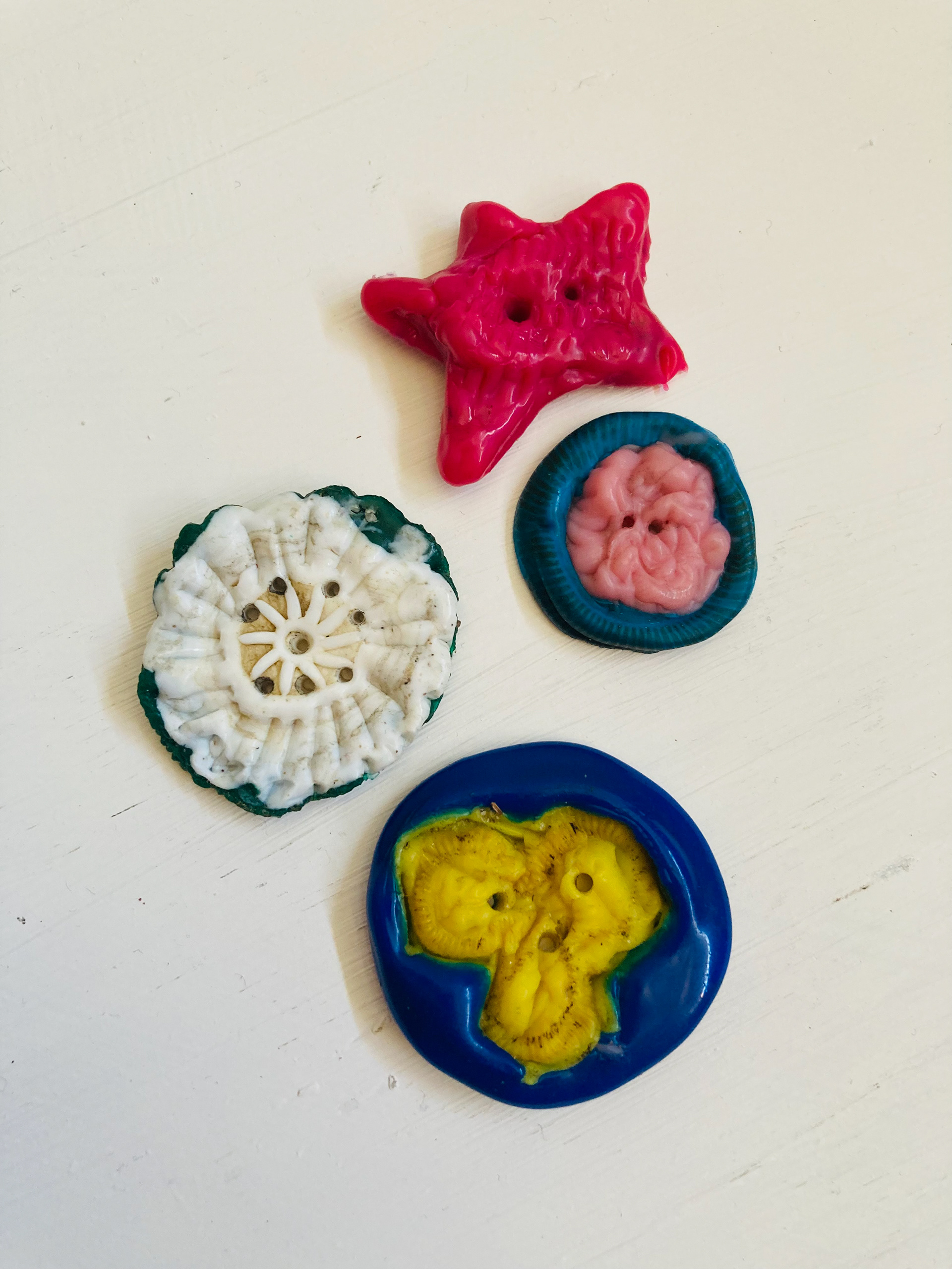 4 buttons made from selected 7 caps