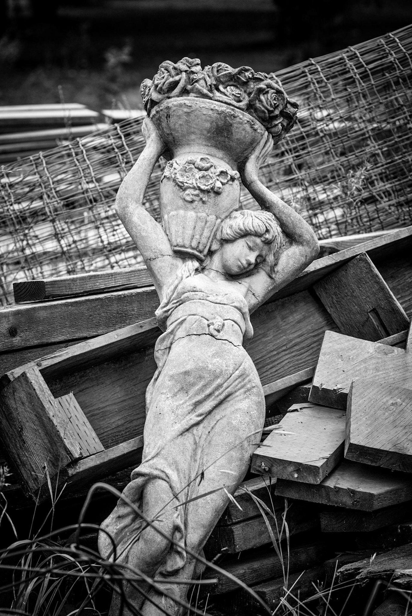 Statue in pile of trash