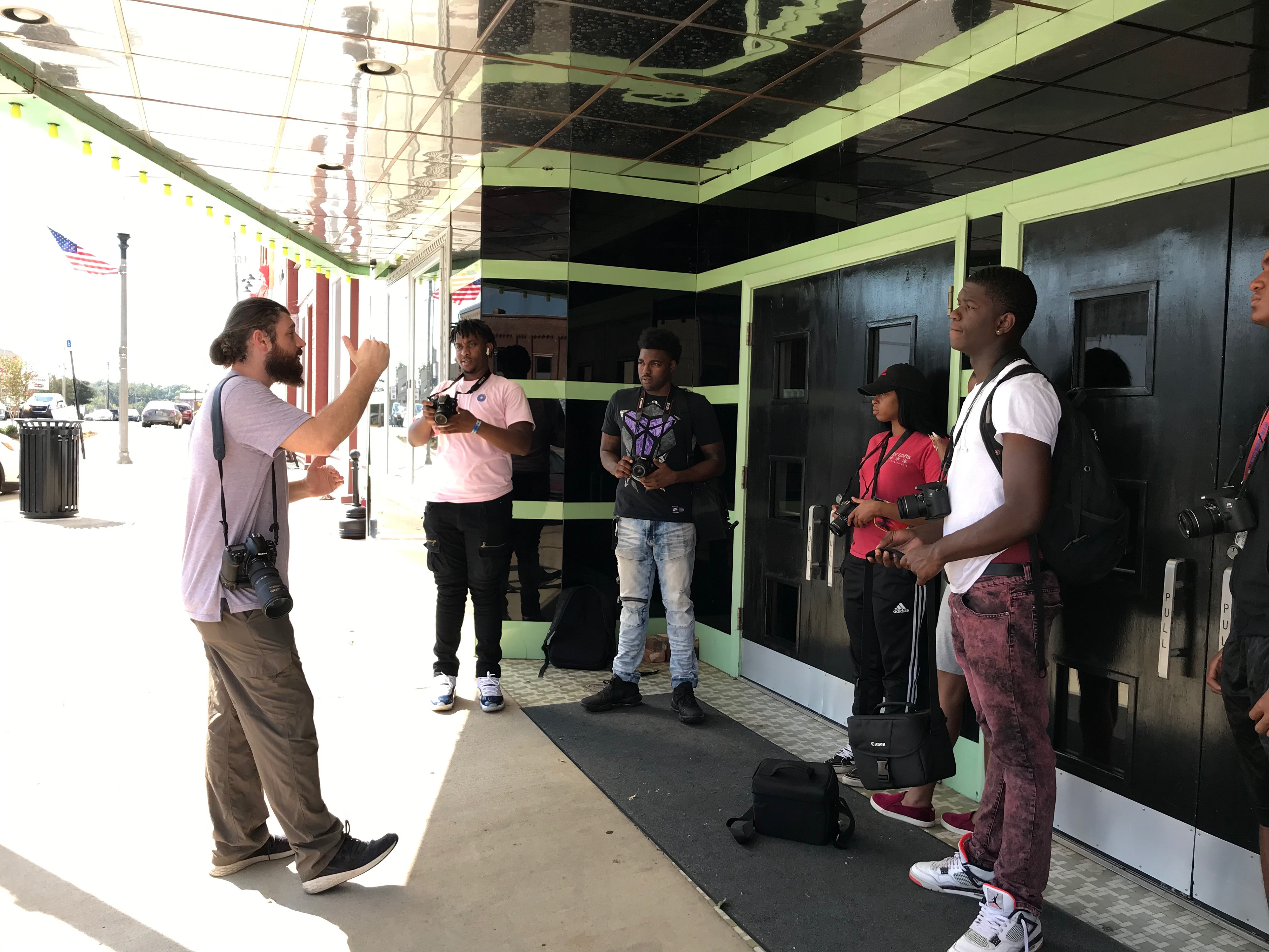 Guest photographer Tucker Webb works with students on the city's historic downtown center