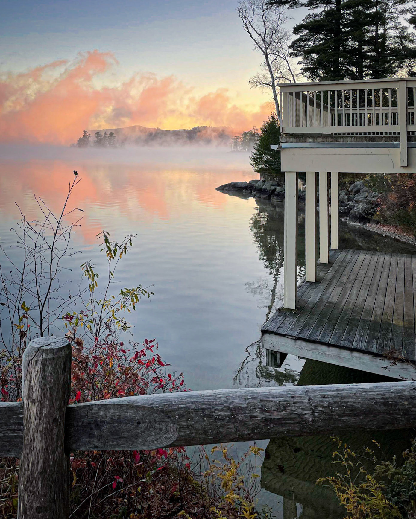 In the quiet calm of the early morniong, the sun paints mist over Lake Wentworth