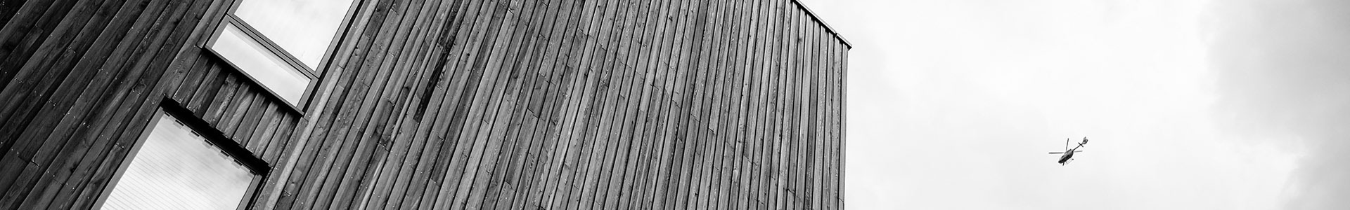 header image of building and helicopter