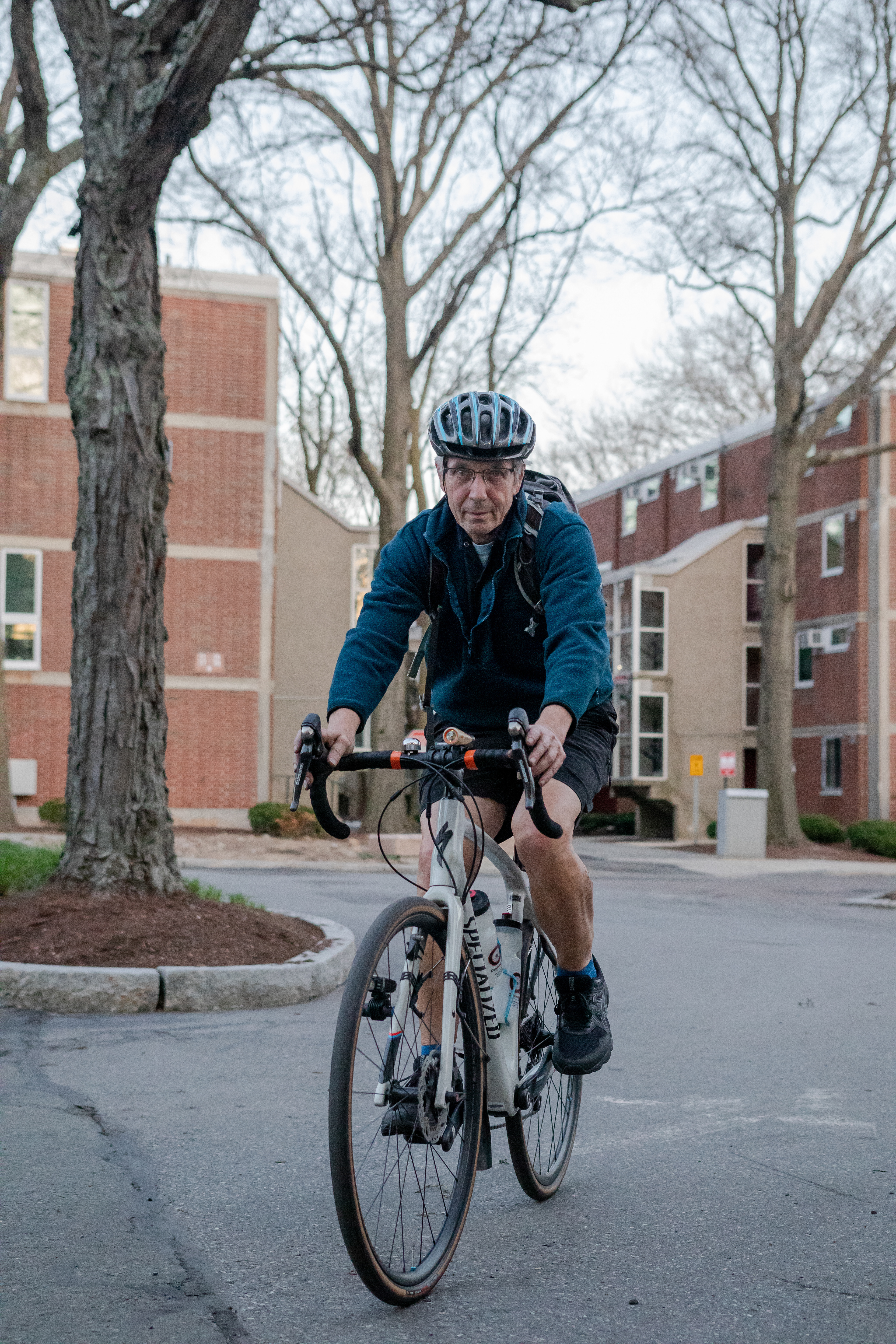 Store owner Rich Coombs sets off on his commute back home after closing shop, April 15, 2022 at Community Bike Supply, Boston, Massachusetts. A bike commuter for 50 years, only taking public transit when biking is not feasible, Coombs sold his car once his daughter was old enough to travel on her own (Ryan Li).