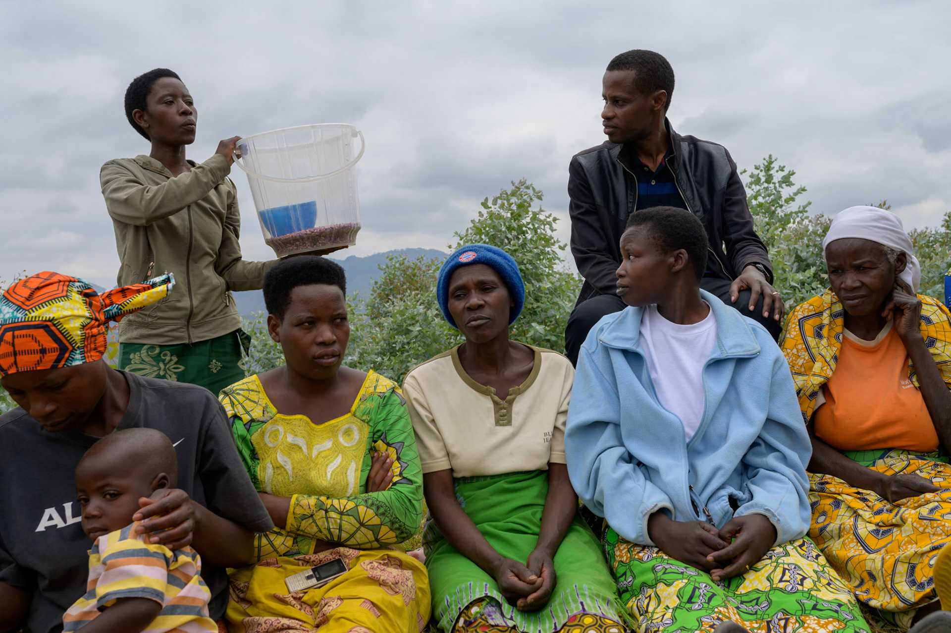 Claudine (standing) from the "Lets Come Together" SHG moved to the village from her home, 90 minutes drive away, to be with her husband.

Her family was living in the forest, but in Kasebuturanyi she had no fiends or connections.

She sells beans and keeps chickens. She has taken a loan to open a store to sell their produce and small goods.