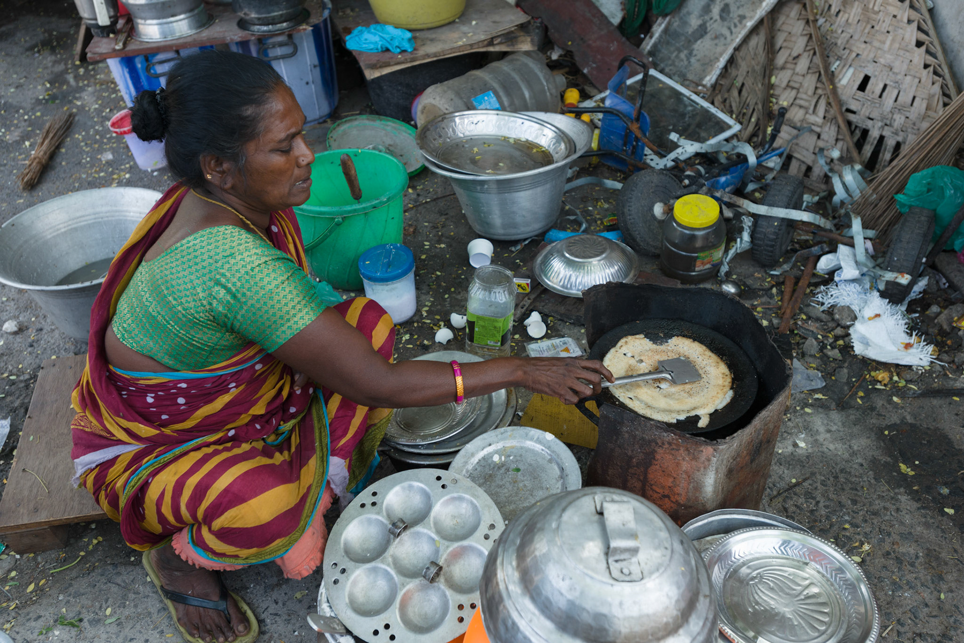 Bhuvanesh Wari making dosa and idli at her shop. An early entrant into the self-help group, she now has several shops, helped by her daughters.