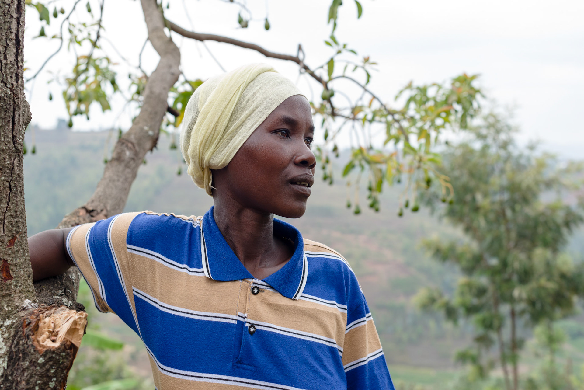 Two years after joining her self-help group, Immaculate now supplementrs her income through buying almonds from growers and selling them at market. here she is leaning on an almond tree.
