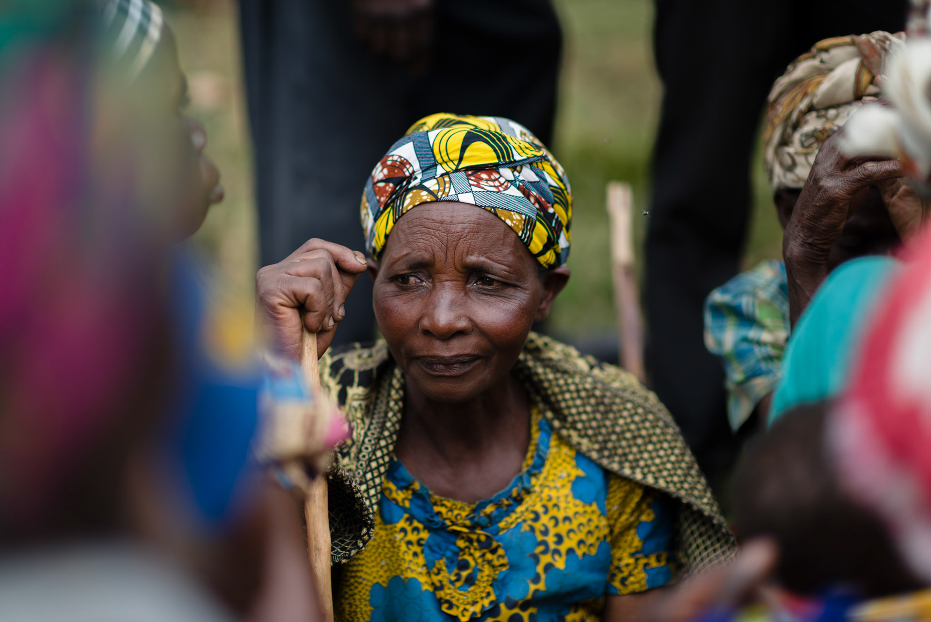 A woman sits while groups are being organised. Groups are formed to keep women together of similar economic category and the proximity of their homes.