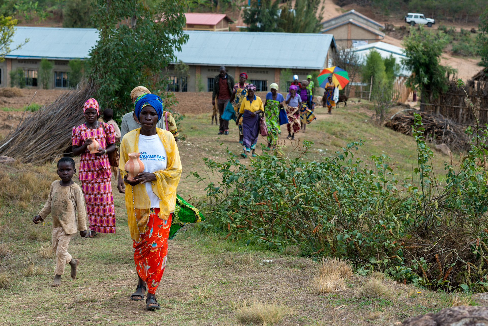 Women arrive for a weekly meeting of self-help groups. Many of the women are noticeably better dressed this year.