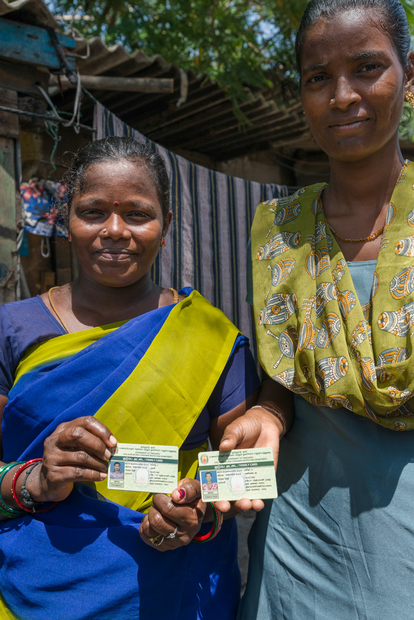 Two women from Equitas self-help groups show the identity cards that they now have.