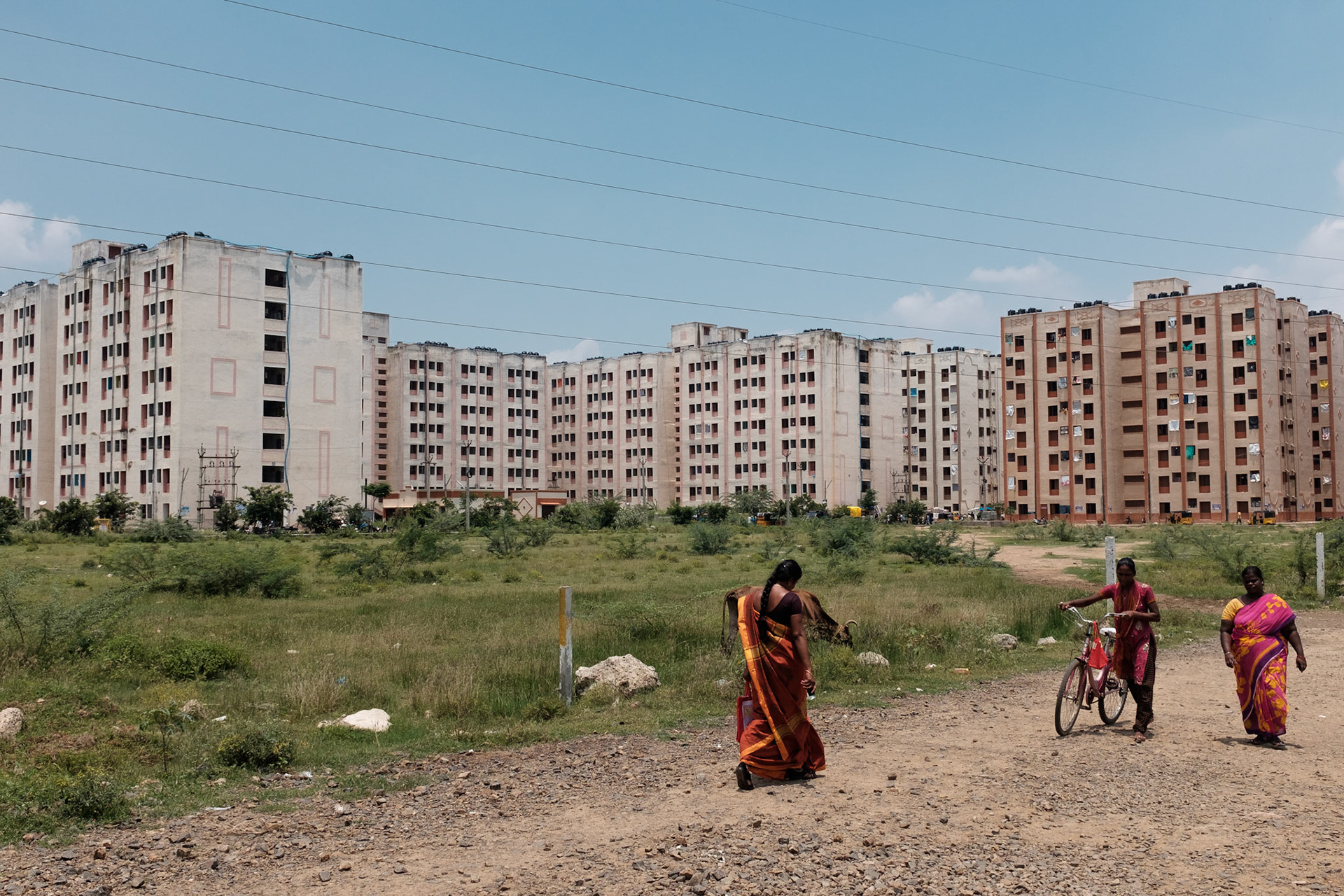 These housing blocks are being built on the fringes of Chennai city. While the hosuing might look spare and isolated, it is nonetheless an improvement over living on a pavement or in a slum.
Within these blocks are small shops, skills training centres, and community actrivities. The housing blocks are being built next to more expensive housing for office and professional workers, creating an economic ecosystem that will provide jobs such as domestic workers, drivers, and other services to their wealthier neighbours.
