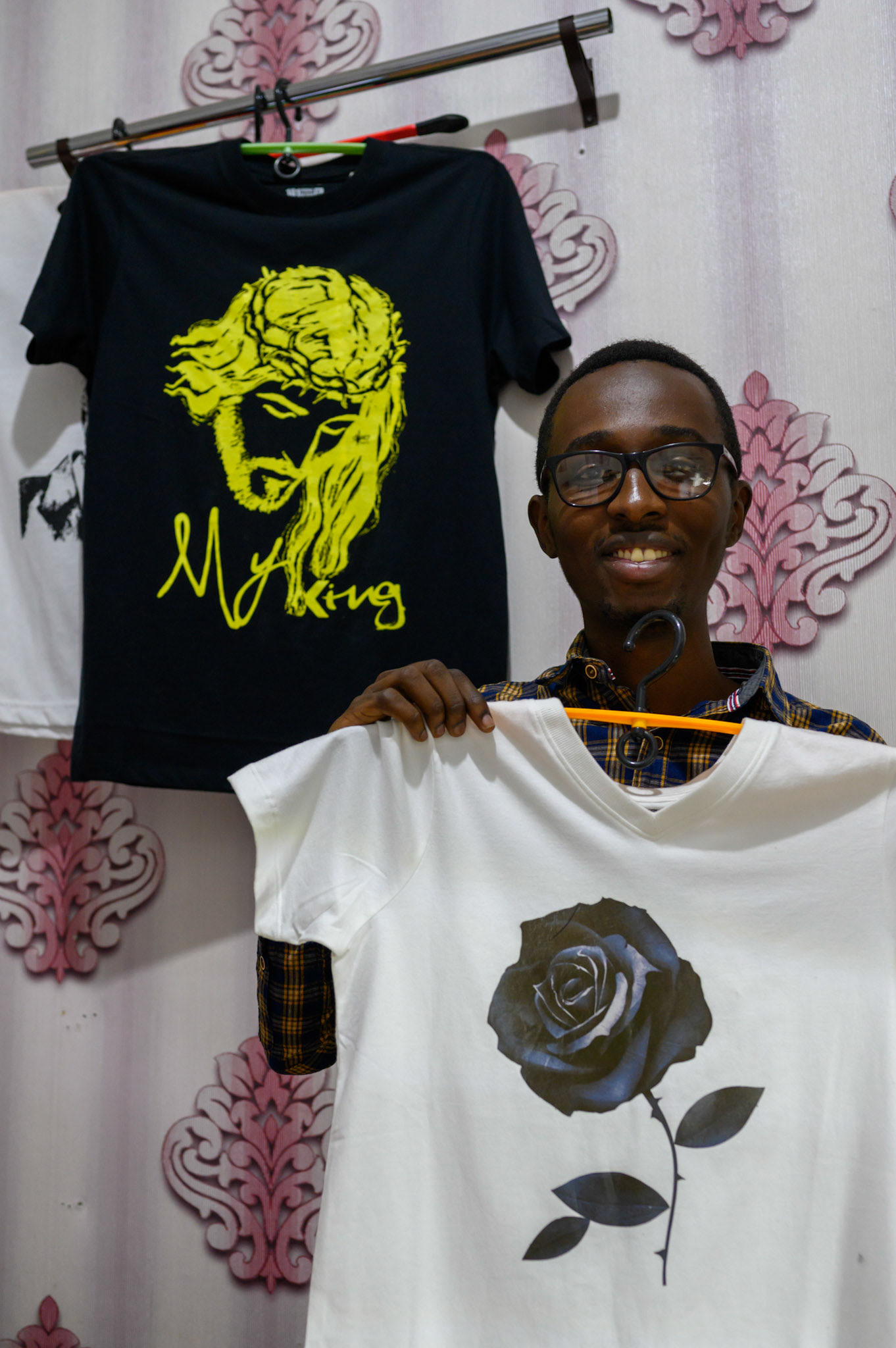 Fiston comes from a fmaily of graphic designers. He has leased an machine for emboidering designs onto shirts and t-shirts. In the first month he has found ten new customers.