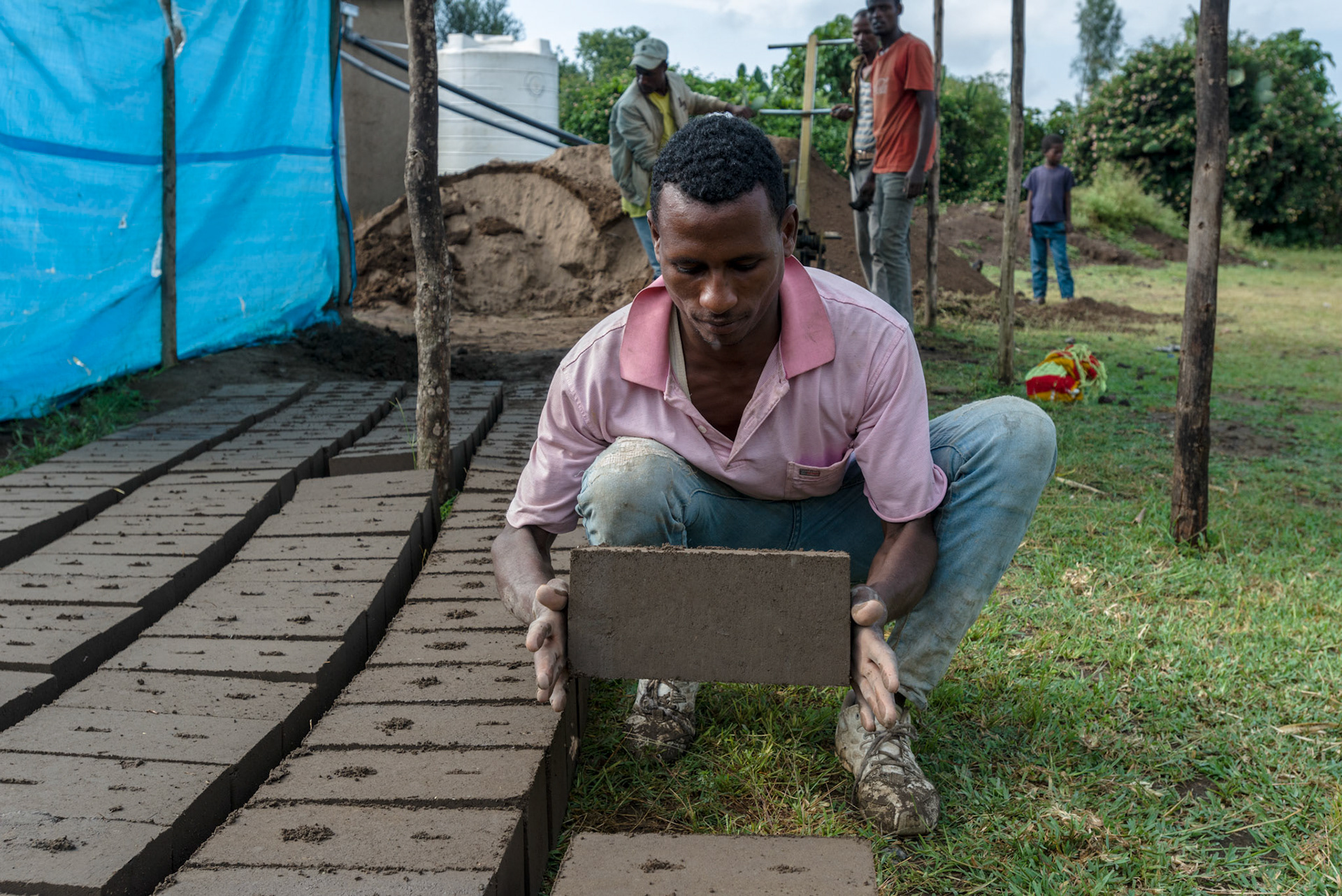 Local men from the Shalla area make bricks to be used in new water tanks.