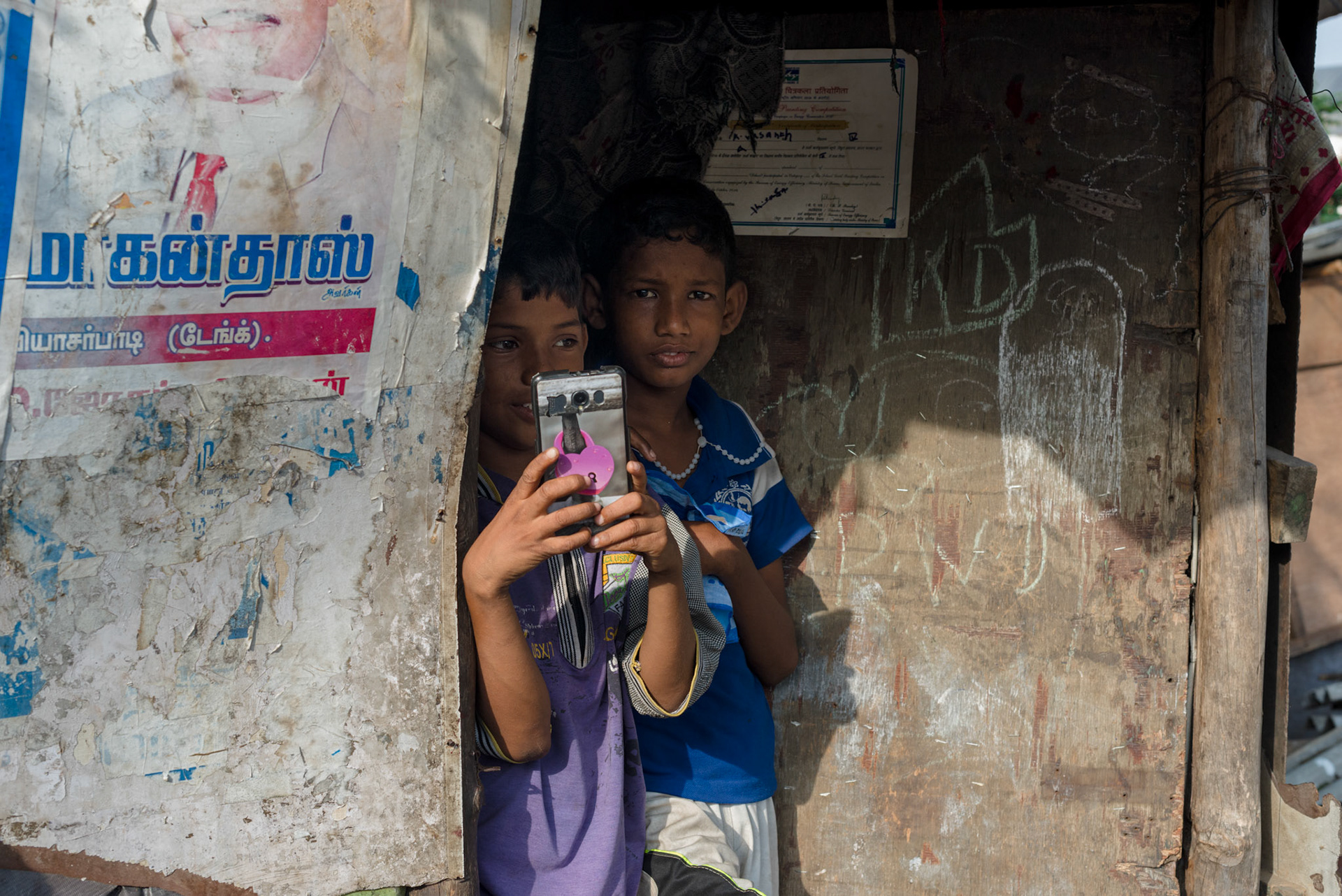 Vasanth photographs the photographer from his shack in Pallavan Nagar.