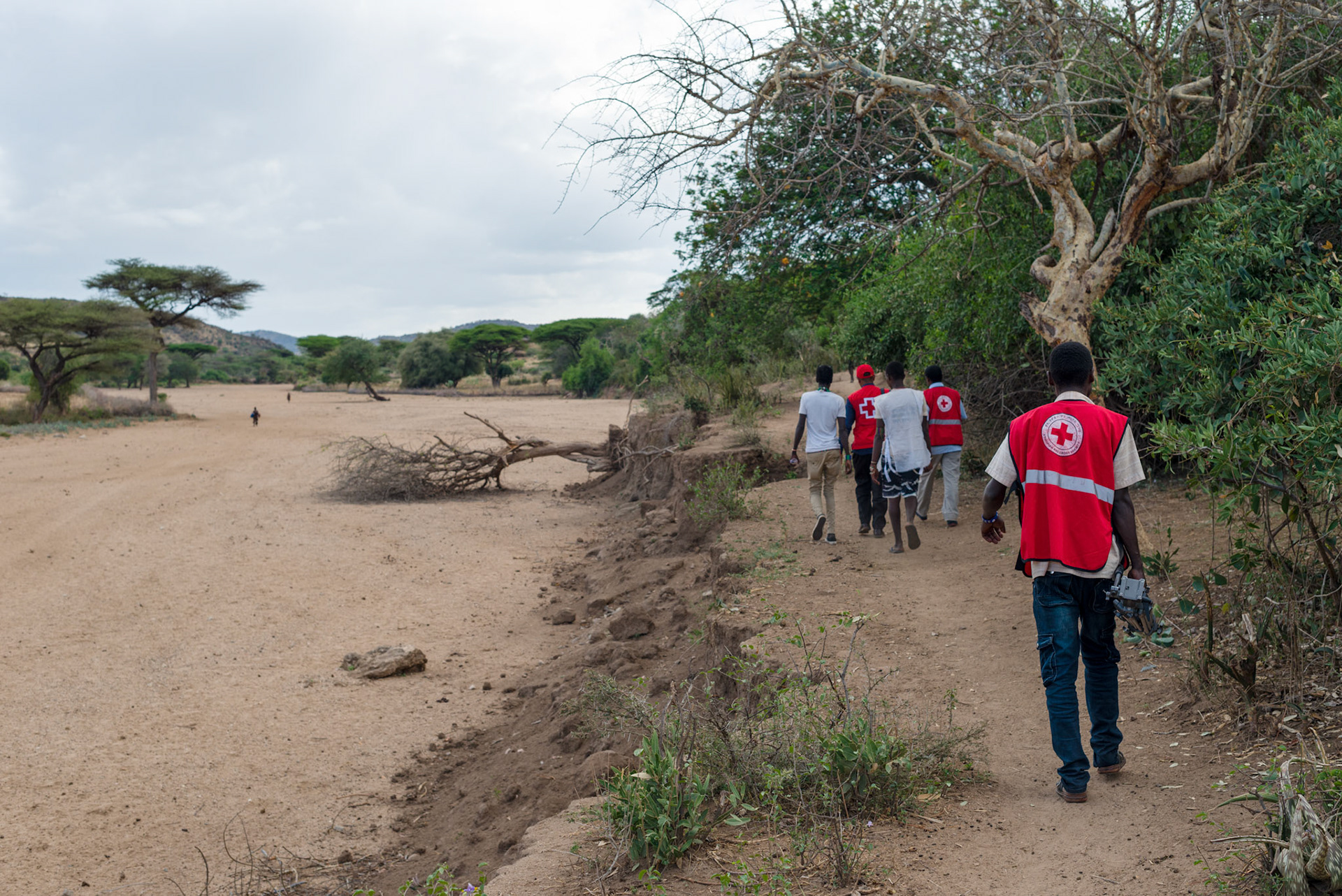 The ERCS team walk to Hamer home to check with a family who received goats in a previous distribution.