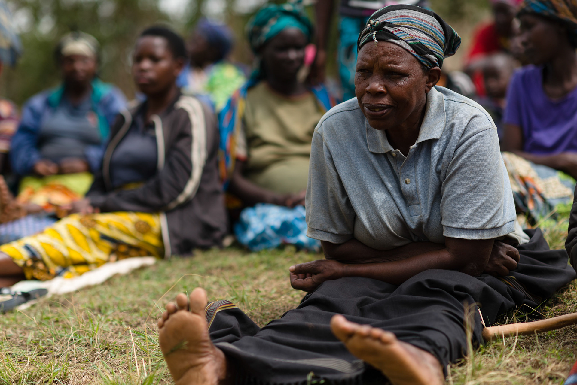 A woman listen as the self-help group approach is explained.