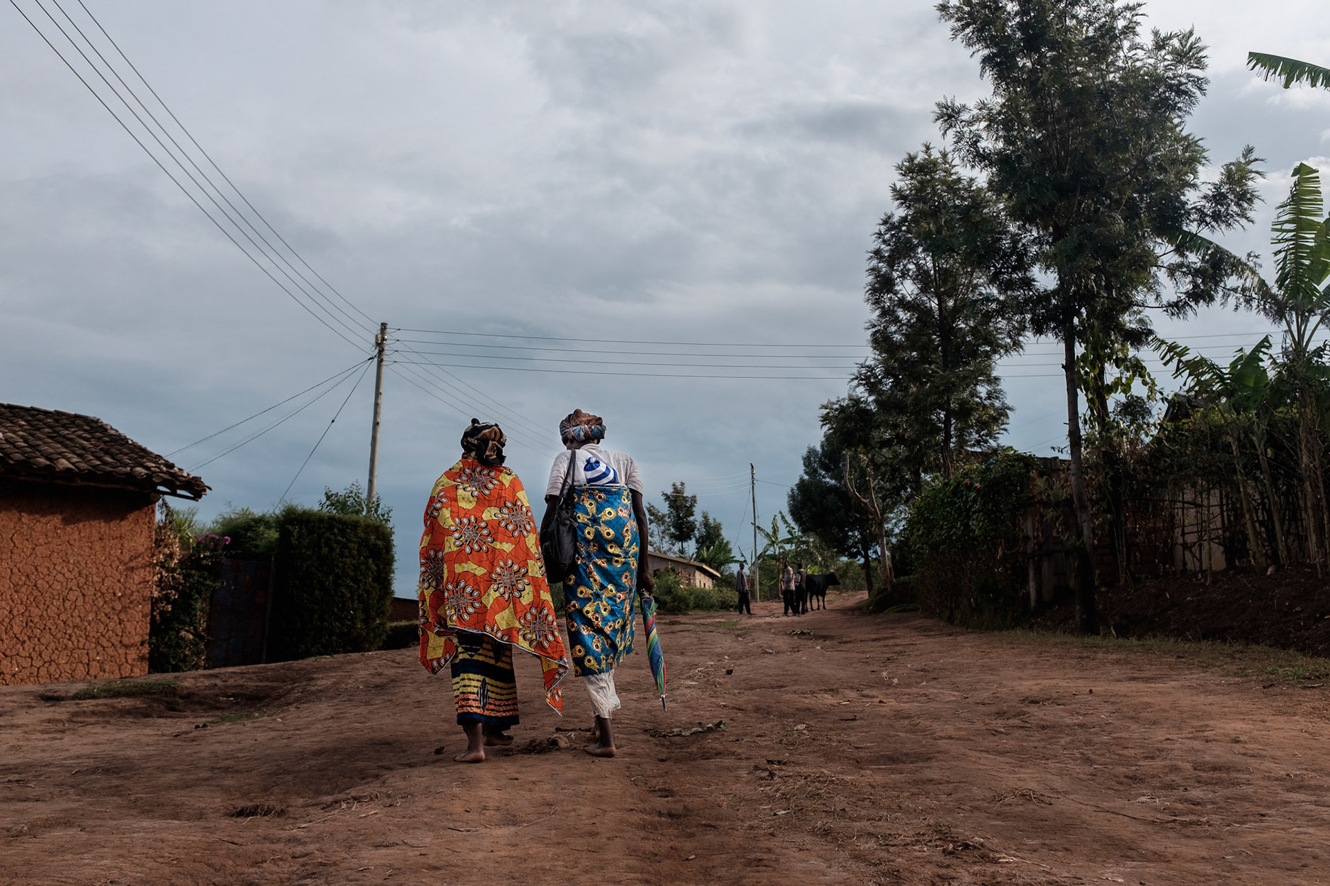 After their first self-help group meeting, Immaculate and a friend walk to the local market to buy vegetables for dinner. The market is located at the top of a hill in another village about 30 minutes walk from Kasebuturanyi.