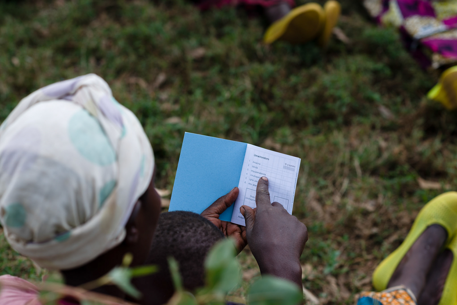 A woman looks at her new self help group savings and loans book