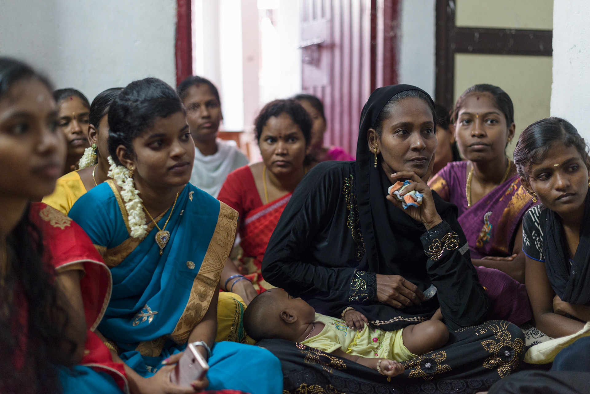 Women from an Equitas sewing skills course listen at their graduation ceremony.
The women live in a large block of government supplied permanent accomodation. There are enough people here for the courses to be run in the blocks.