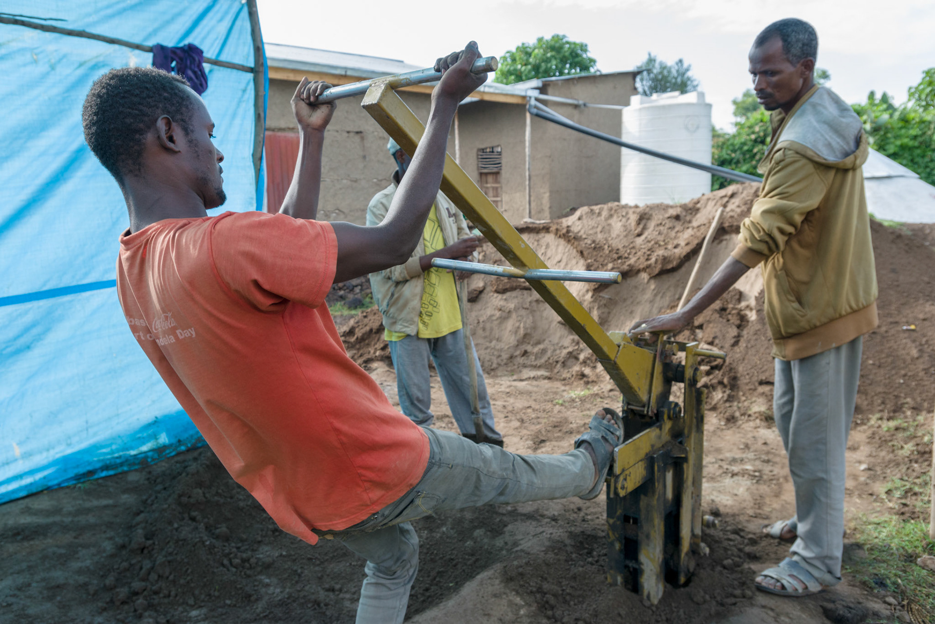 Local men from the Shalla area make bricks to be used in new water tanks.