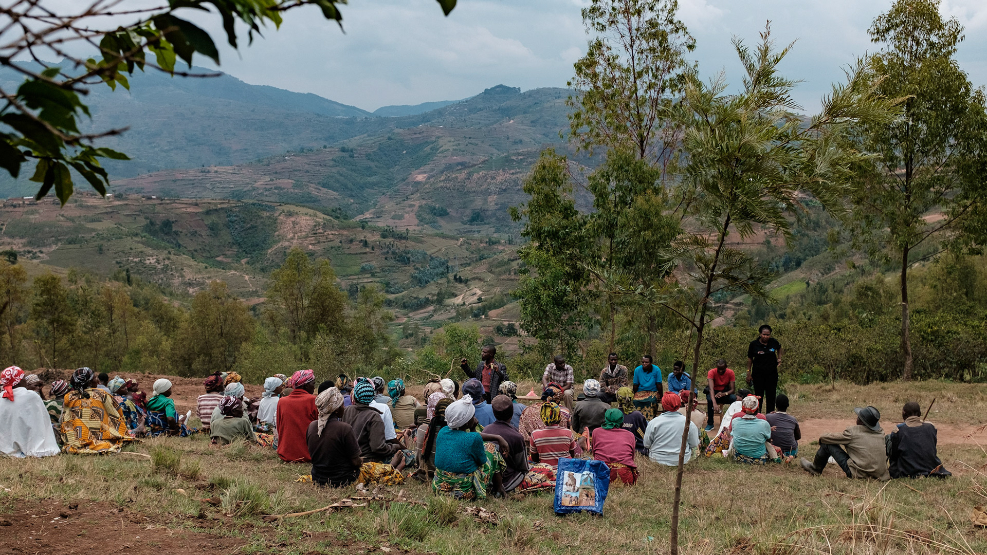 Today the women of Kasebuturanyi have assembled to hear AEE, a Rwandan NGO, exmplain the self-help group approach to poverty alleviation.
Some of these women have friends who have already joined self help groups in other villages, but for others, this is the first time they are hearing of the groups.