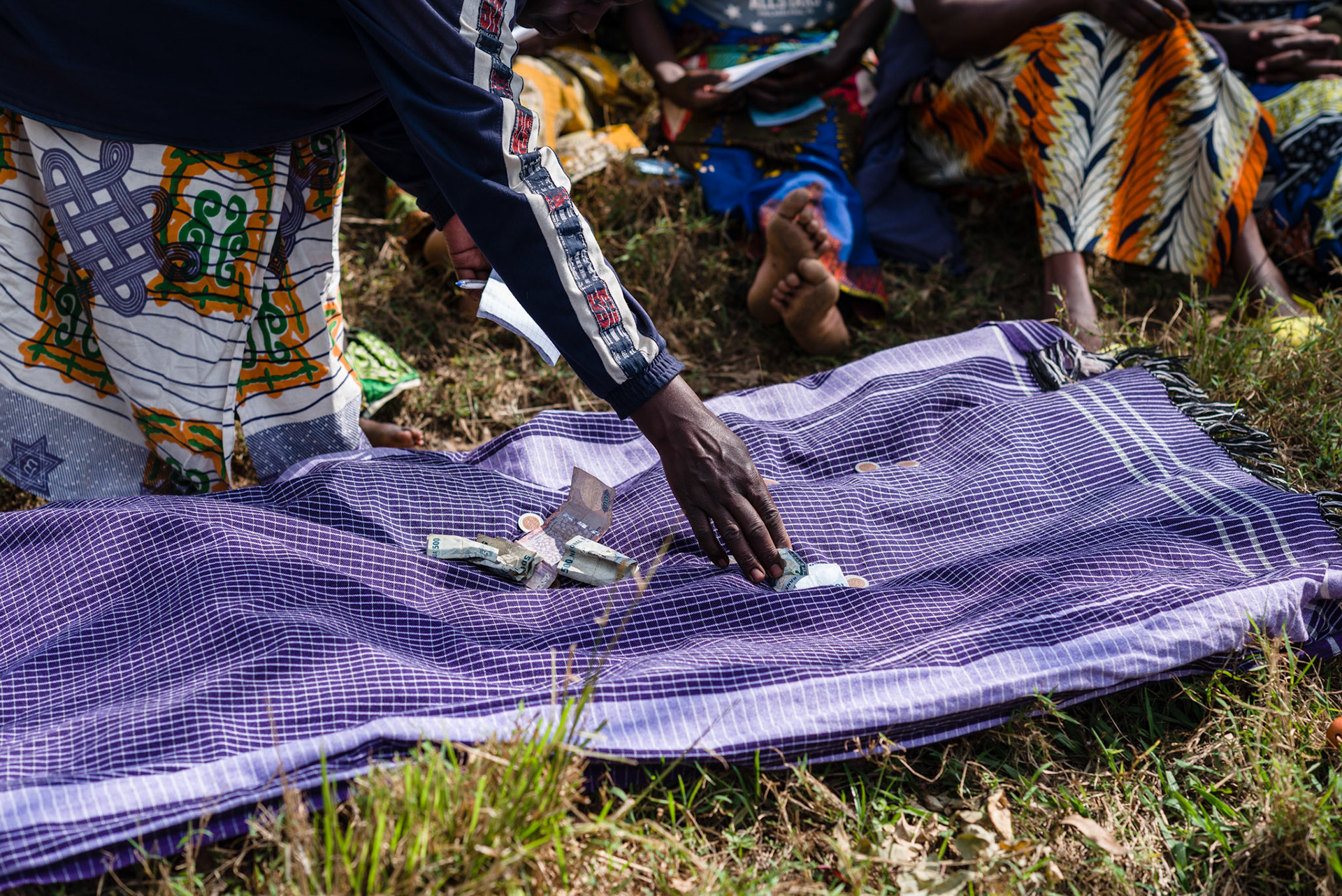 A new self help group meets to put money into group savings for the first time.
The women put money into the centre as their name is called from the roll.