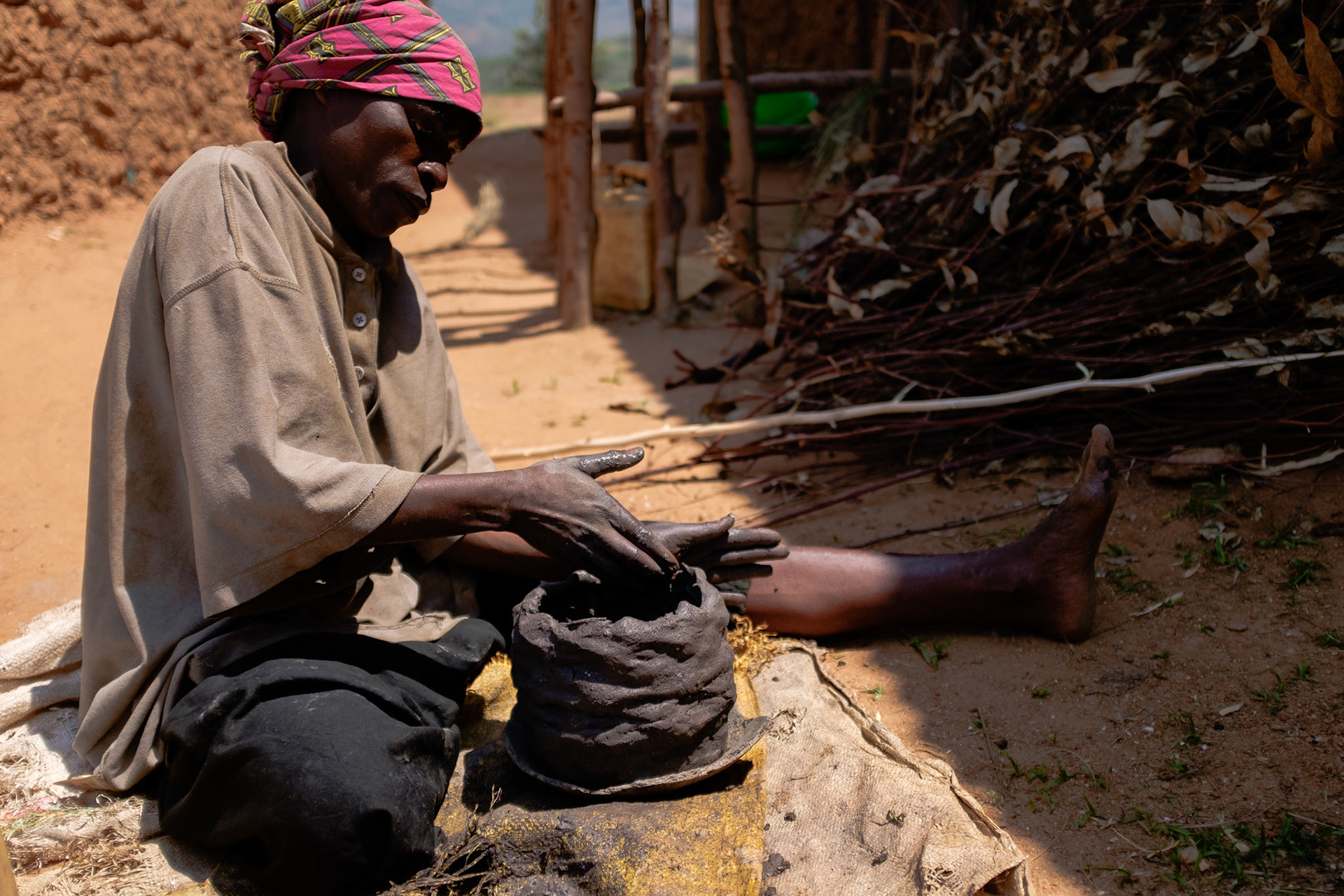 Making clay pots is a traditional craft for Twa; however the demand for pots has largely been displaced by plastic and meta. She can sell her pots for only twenty or thirty US cents each.