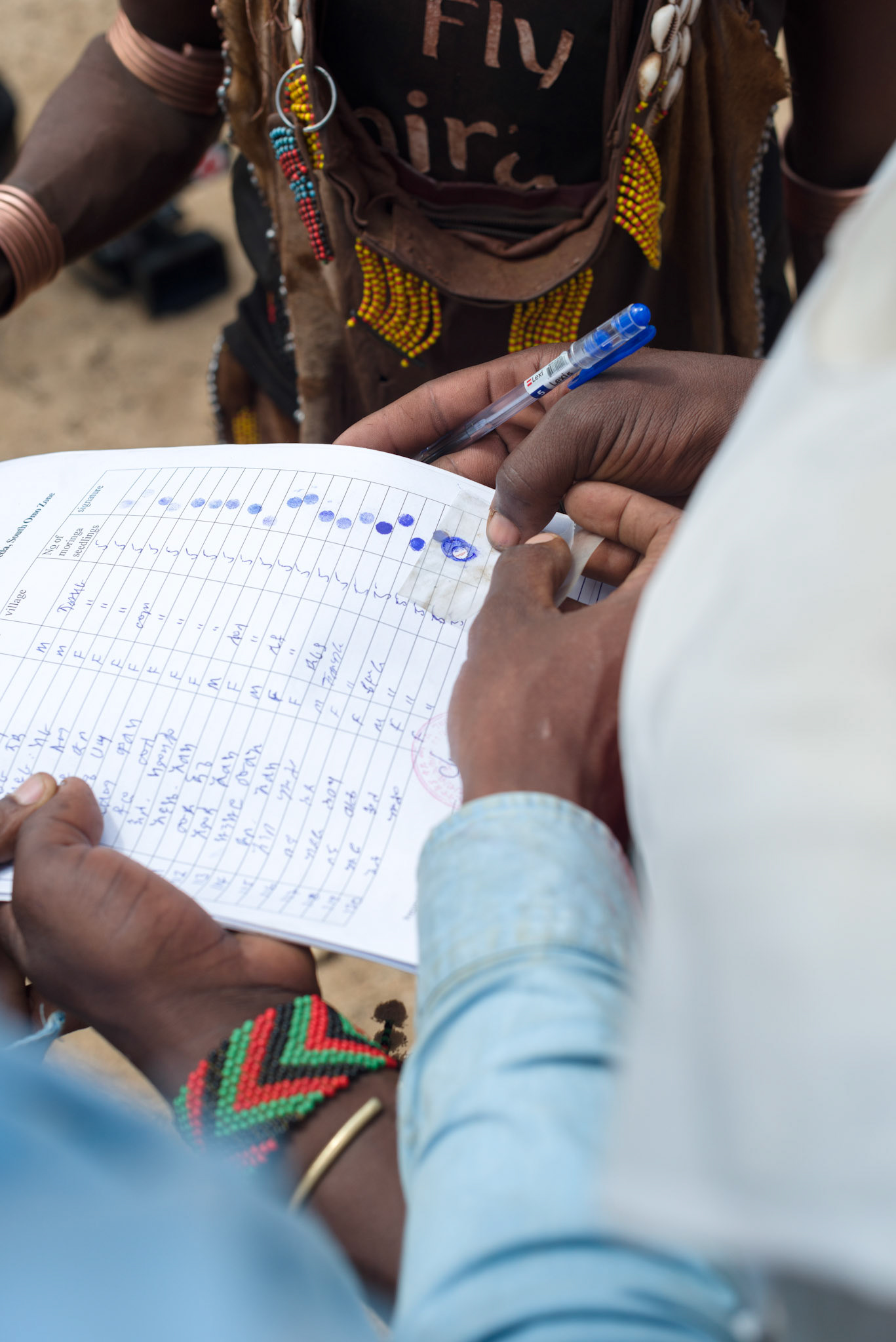 A Hamer woman registers for her plants with her fingerprint.