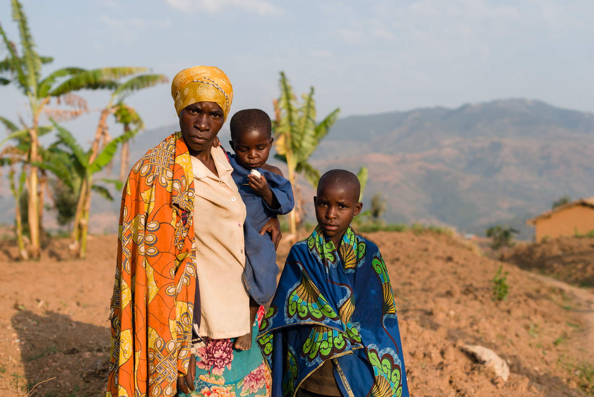 Philomene with two of her three children, Claire and Ishemwe, a year on from joing her self help group.