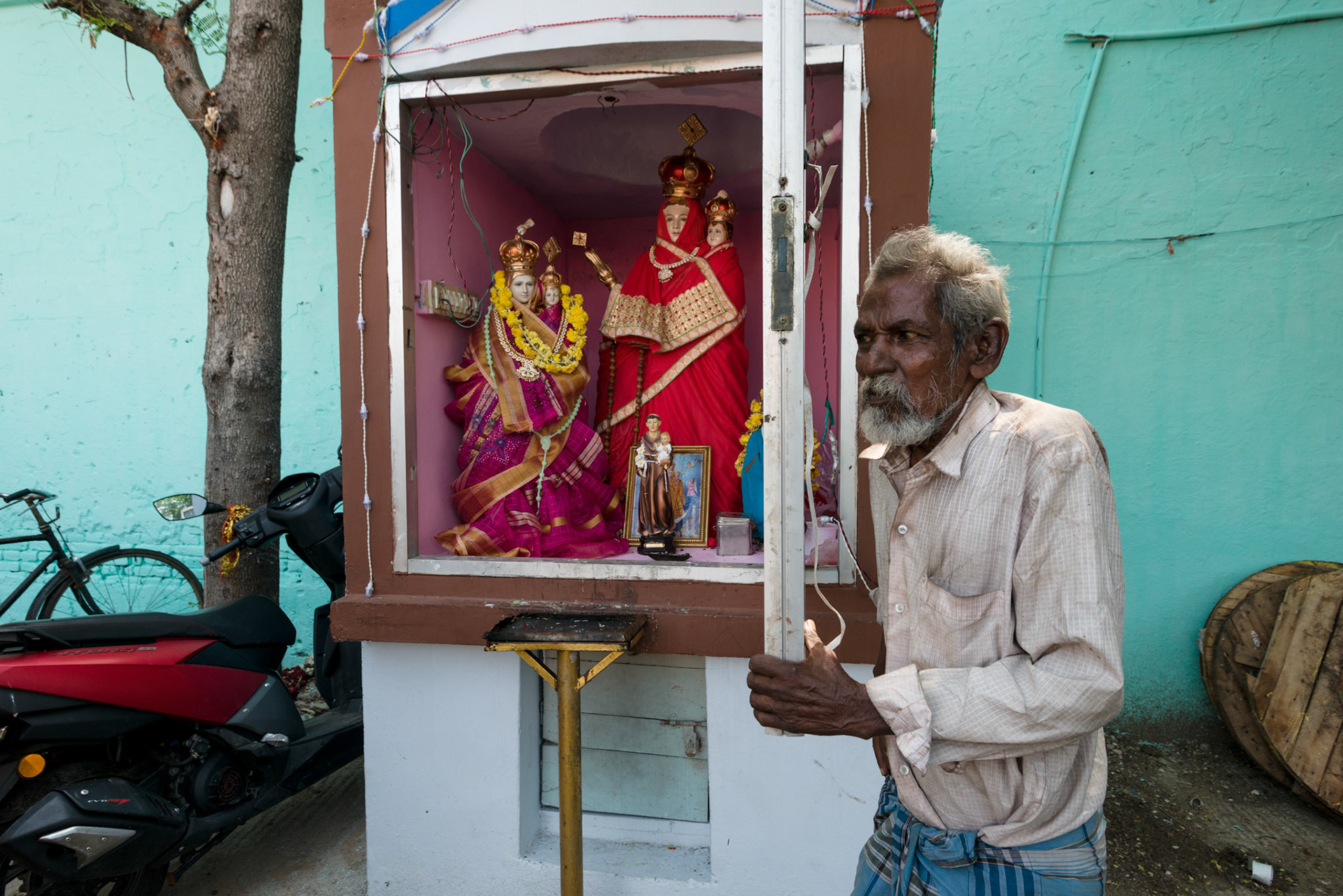 Venkatesh, 63, is the guardian of the Christian shrine. Although the figures are Roman Catholic, they have been dressed in saris and robes, and adorned similarly to Hindu idols.