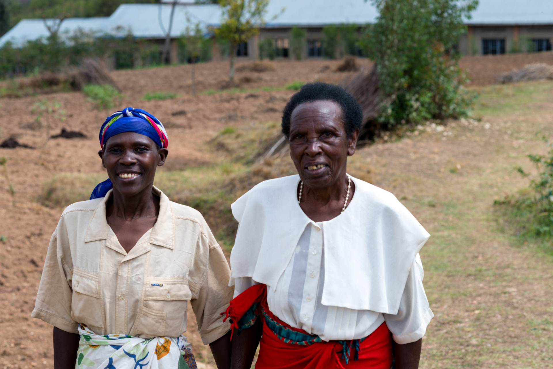 One year on, Ancille walks to a self-help group meeting with a friend.