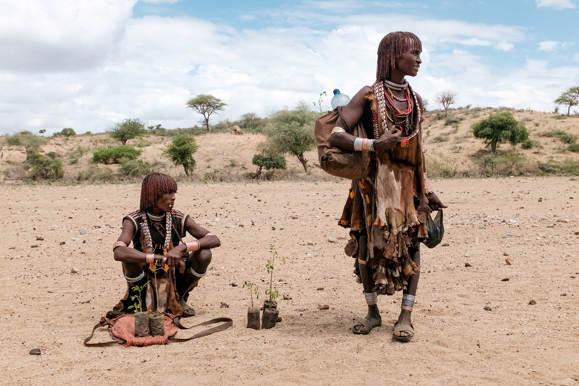 Two Hamer women from the Asile kebele with their moringa seedlings. The seed pods from moringa trees are used for food and as a cash crop.