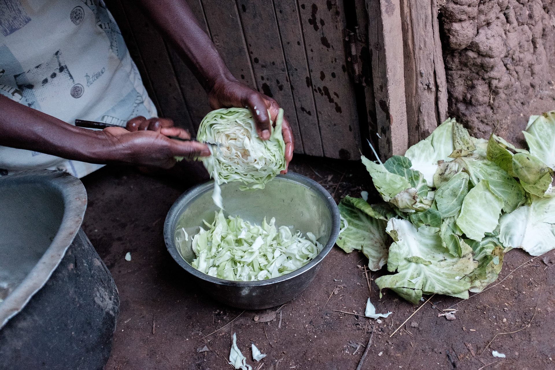 Immaculate prepares a dinner of cabbage in the evening. This is the family's only meal of the day.