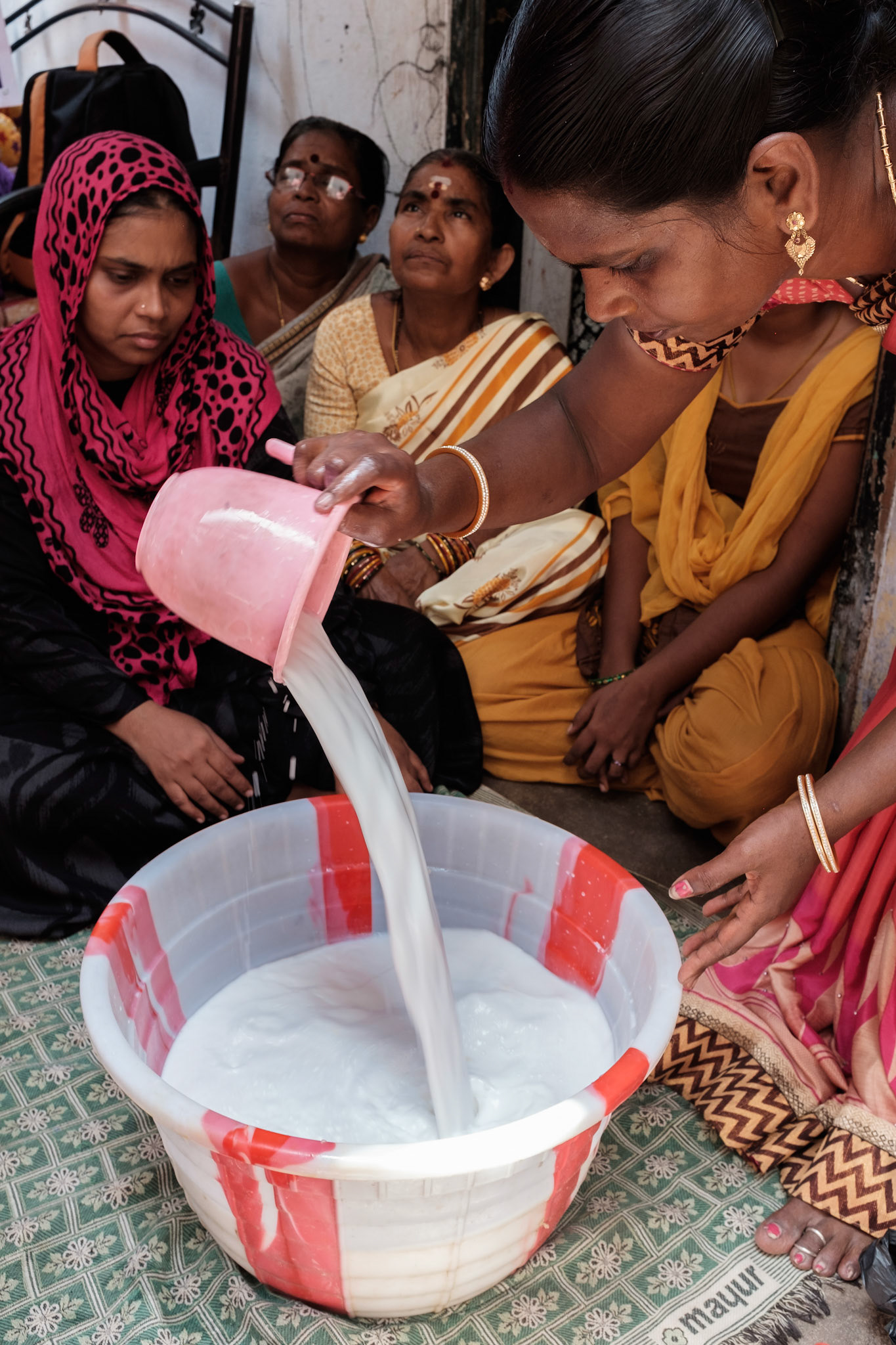 Women in a self-help groups are trained in making detergent for cleaning toilets. They will both use and sell what they make.