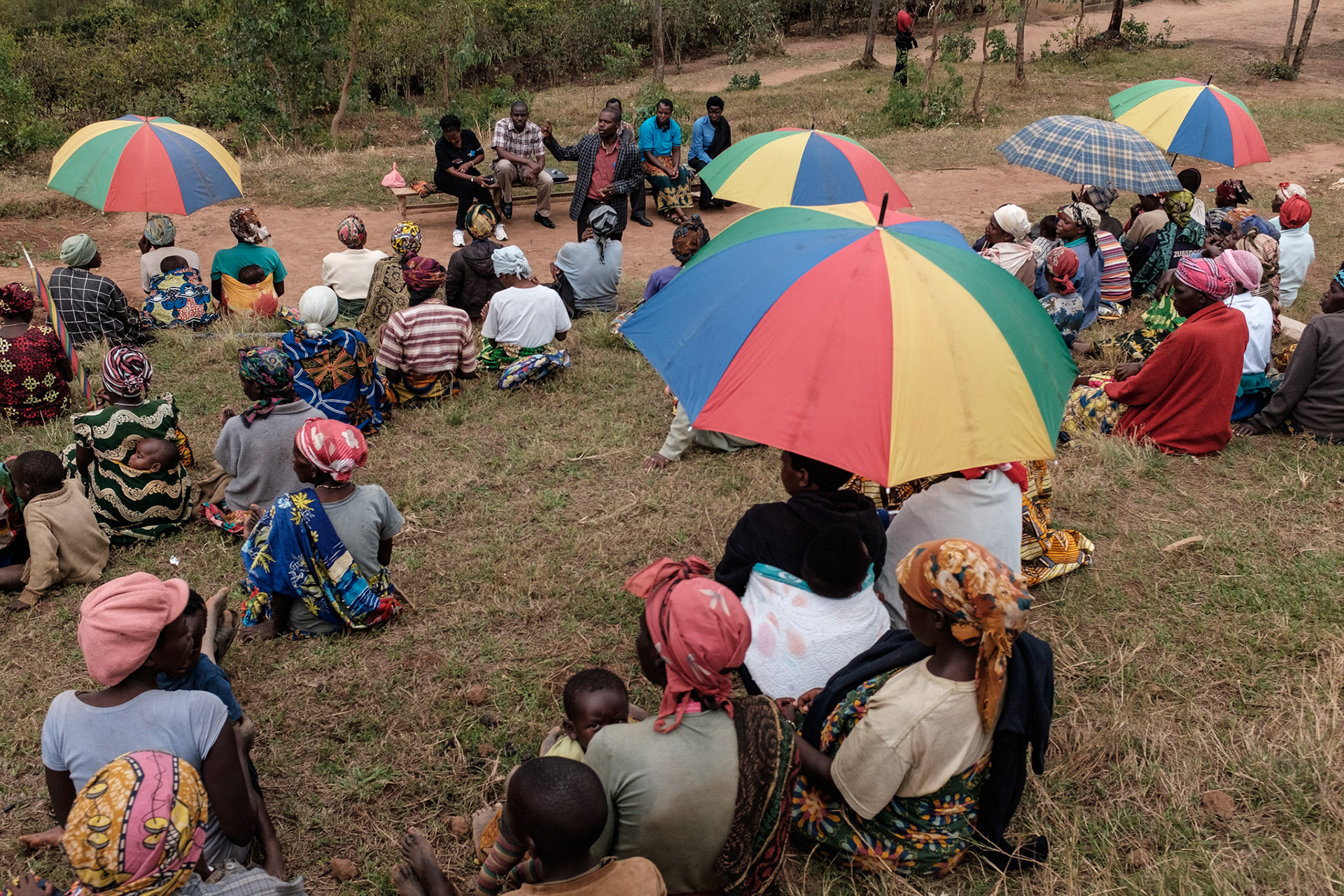 Kasebuturanyi women listen as AEE explain the self help group concept. Some of these women have friends who have already joined self help groups. For others, this is the first time they are hearing of the groups.