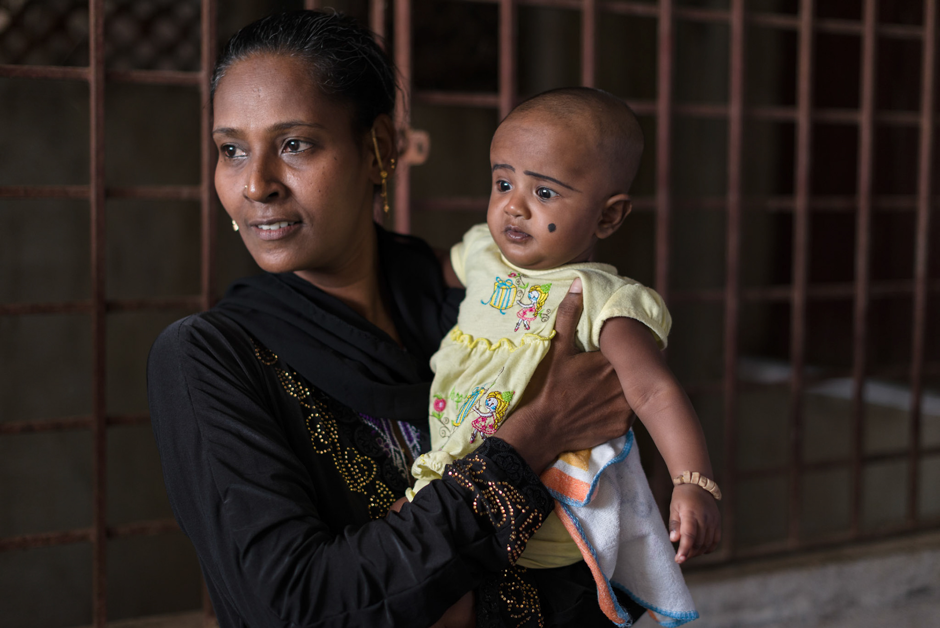Noor Jahal,, a graduate of the Equitas sewing skills class, with he baby.