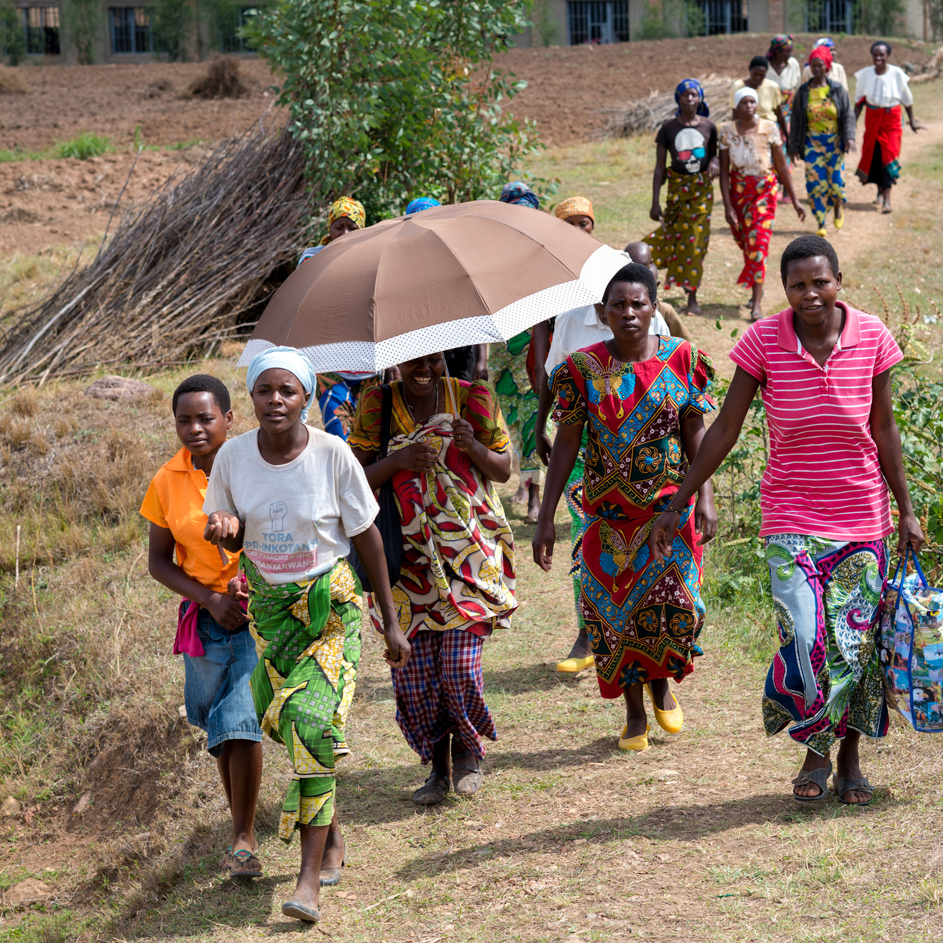 Women arrive for a weekly meeting of self-help groups. Many of the women are noticeably better dressed this year.