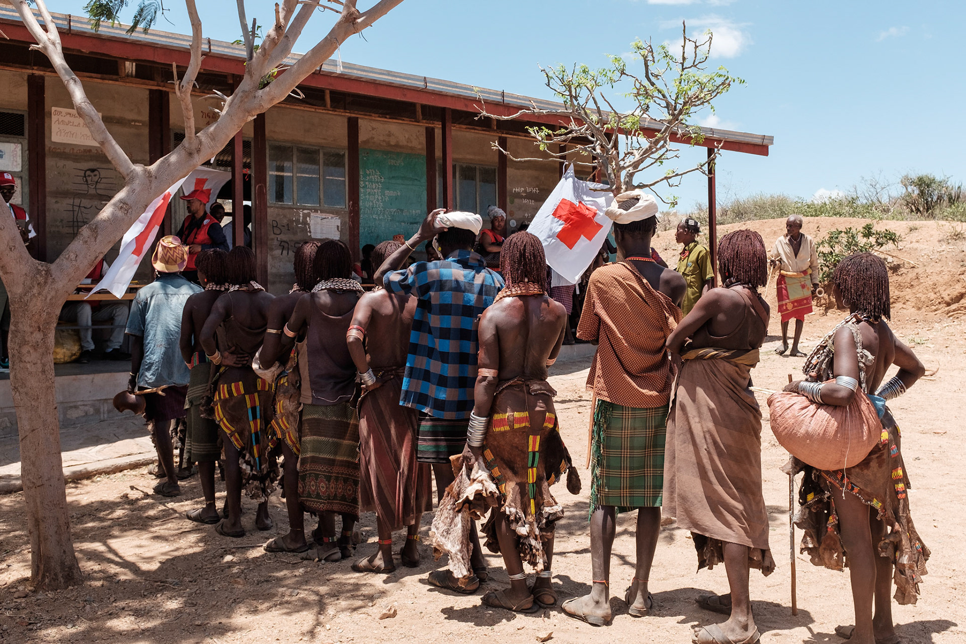 Hamer people queue to receive their goats.