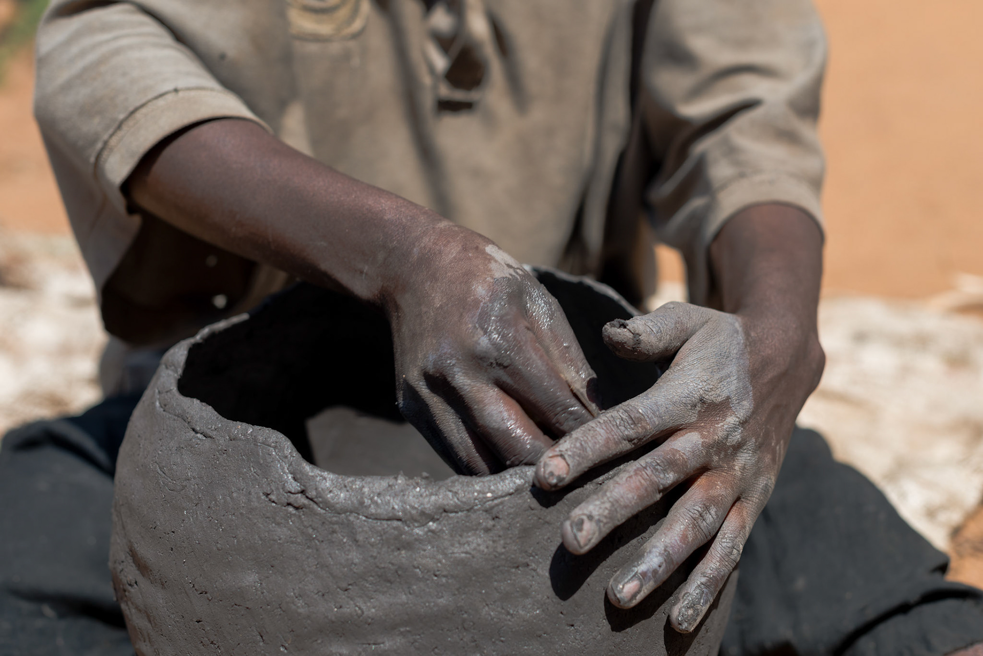 Making clay pots is a traditional craft for Twa; however the demand for pots has largely been displaced by plastic and meta. She can sell her pots for only twenty or thirty US cents each.