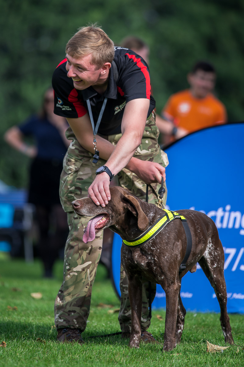No cheating now!. Ensuring the explosives detection dog does not see where the 'bomb' is being hidden.