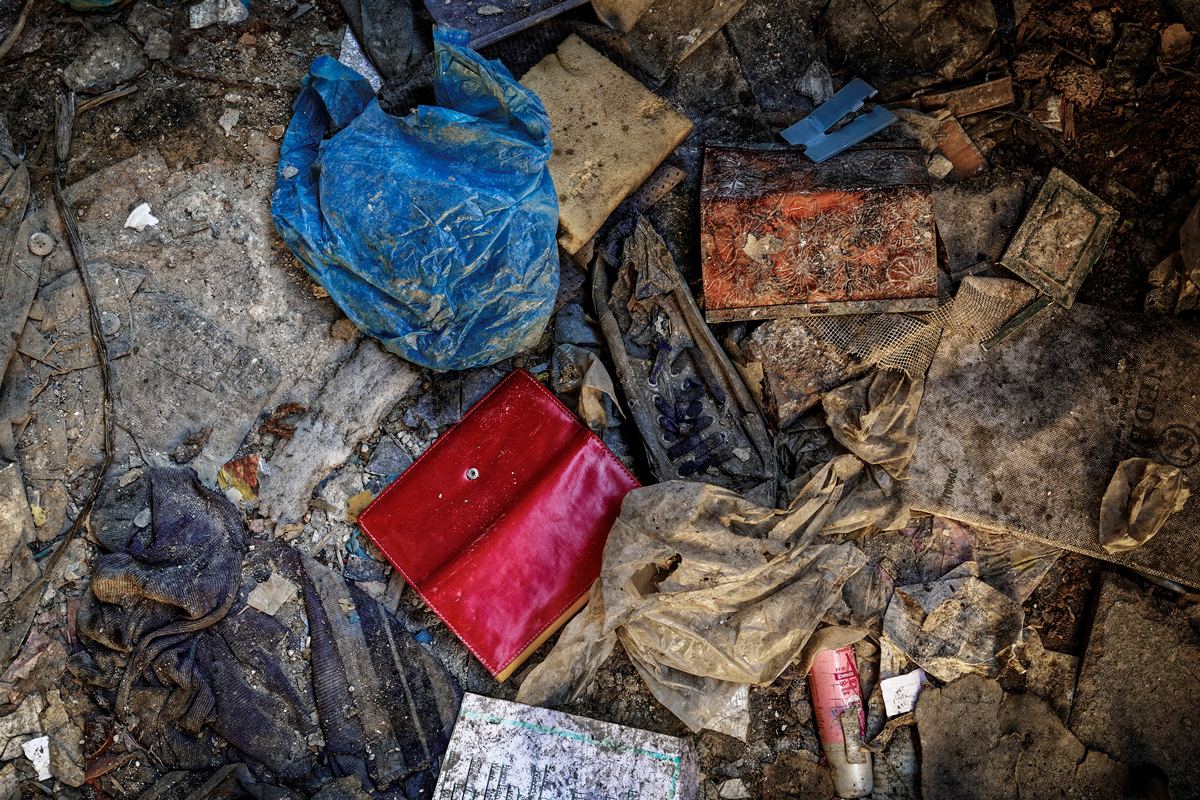 A Womans Possessions 2014 - 2016 Photographic Print UV Print, Lightbox 850mm x  850mm. Two woman's purses lie on the ground floor of Dark City as a result of muggings. A Nedbank money bag lies amongst the possessions showing us a bag that most likely contained someones monthly salary. The discarded possessions have started to decay with the rest of the building as if nature is taking it's course and the reoccurrence of this act is imminent.