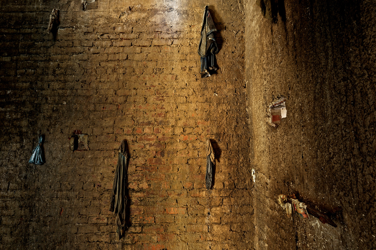 Elevator Shaft 2014-2016  Photographic Print Fine Art Cotton Rag A0. The elevator shaft of Dark City was filled with four stories of trash including the basement and elevator pit. All metal had been stripped from the elevator to be sold as scrap metal. Residents using the shaft as a rubbish dump would throw their trash into the elevator shaft but some items would get stuck on the few pieces of metal sticking out of the wall and remain eerily suspended.