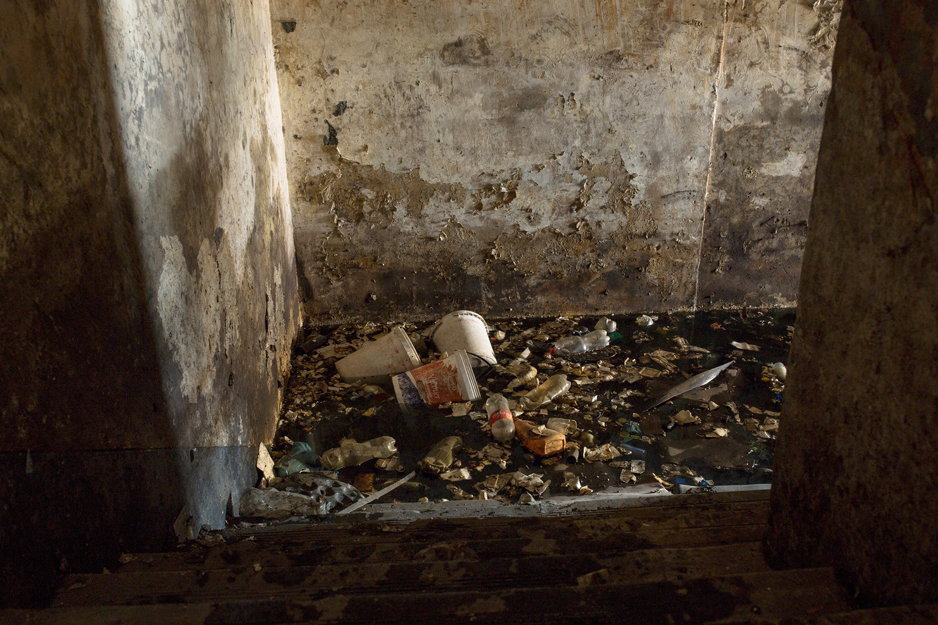 Basement 2014 - 2016 Photographic Print Fine Art Cotton Rag A1. After construction began the basement was being drained of water and trash was being removed. In the process two decaying bodies were pulled from the rubbish each decapitated and cut in half at the torso.