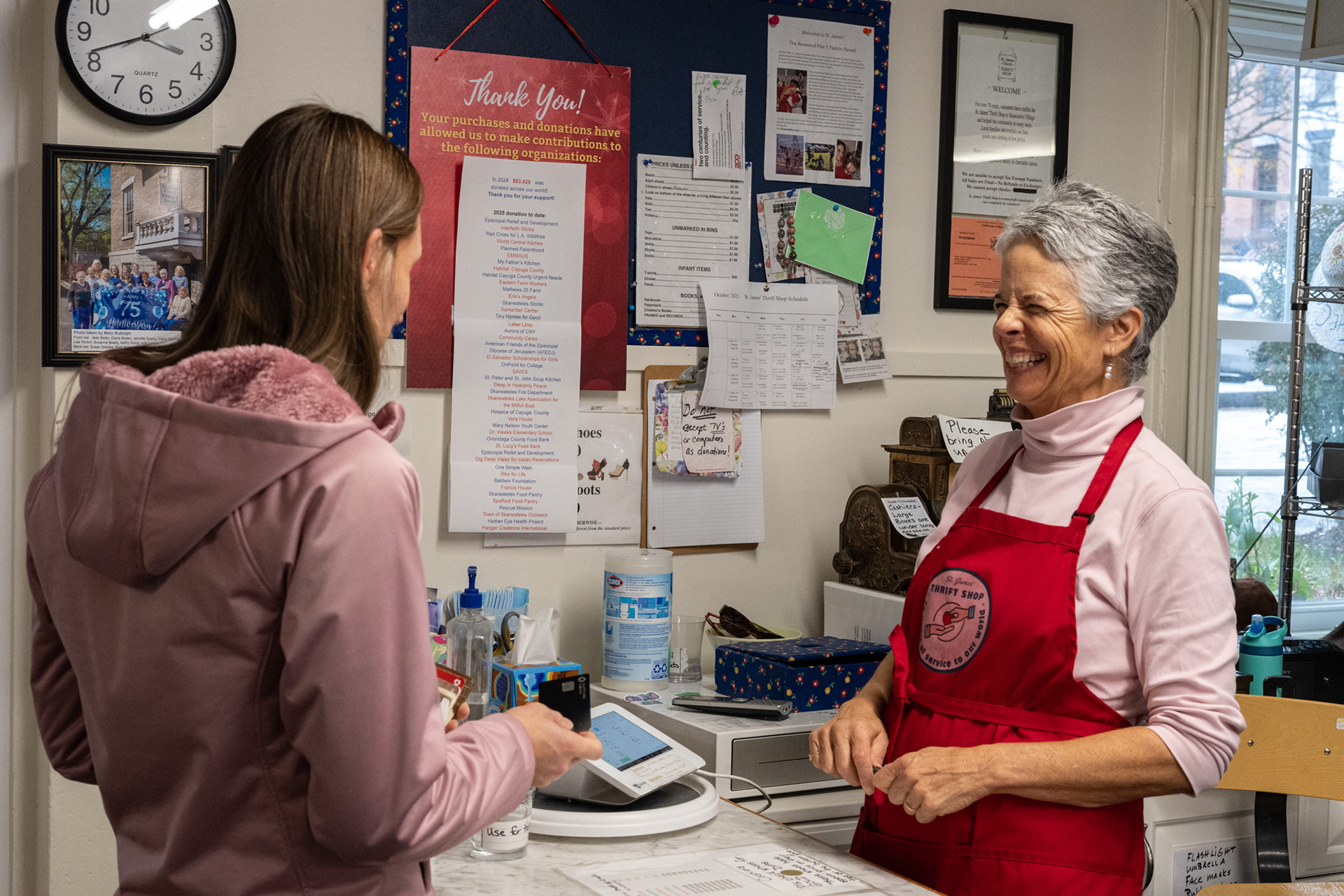 Carolyn Legg checks out a customer.  The store frequently helps those in need in the local area. For example, they recently donated $12,000 to the Skaneateles library.